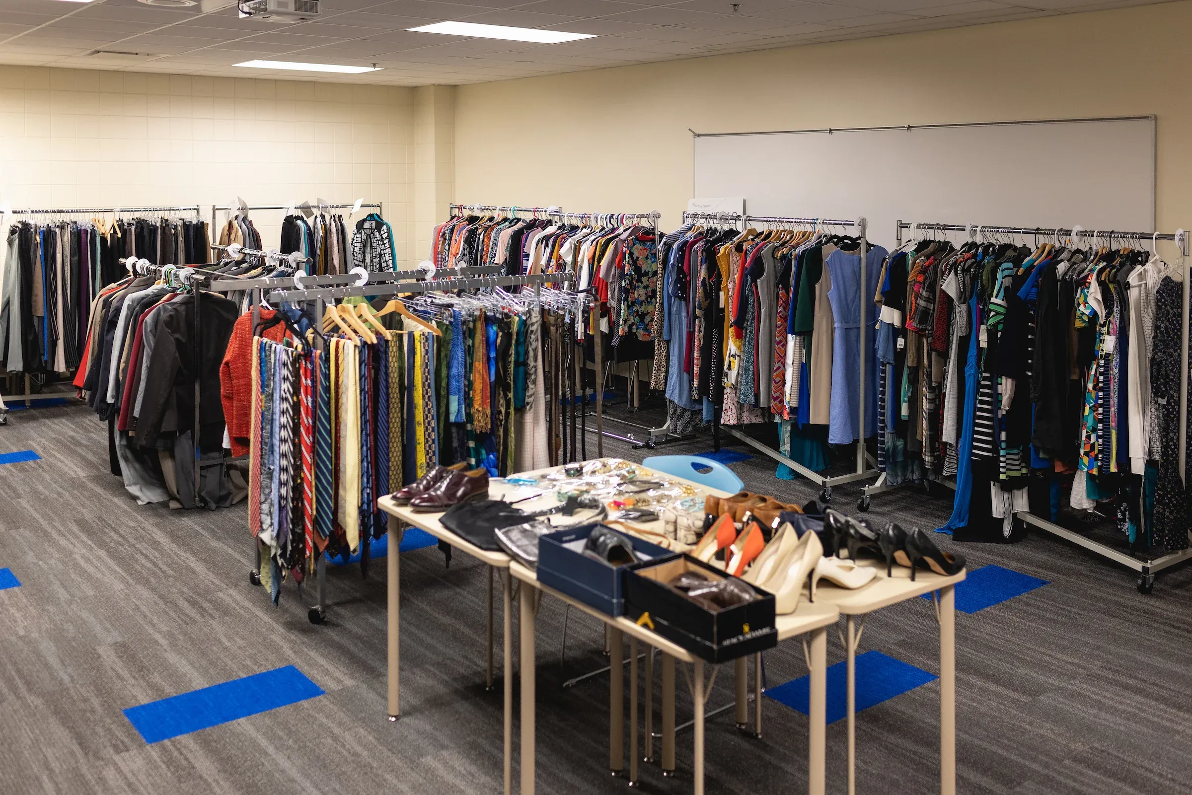 Racks of donated professional clothing and shoes in the clothing closet