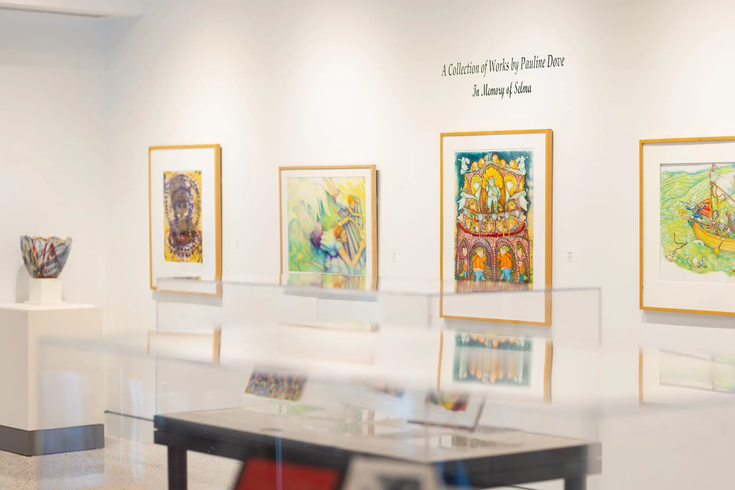 Framed artworks on display in a campus gallery