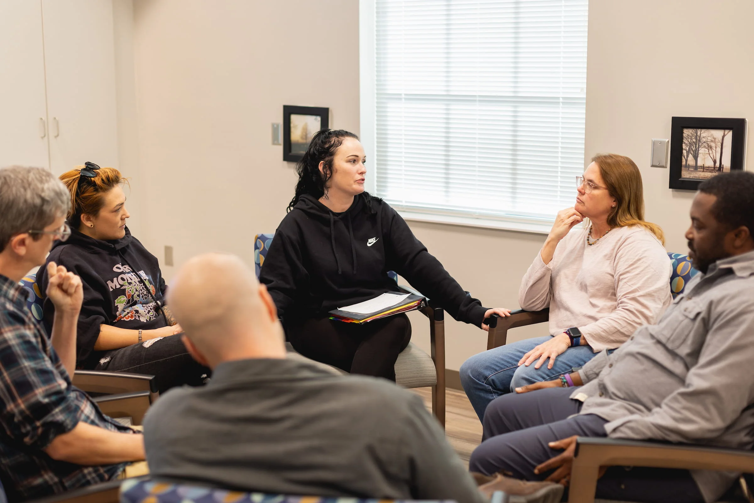 Group seated in a circle during a counselling session