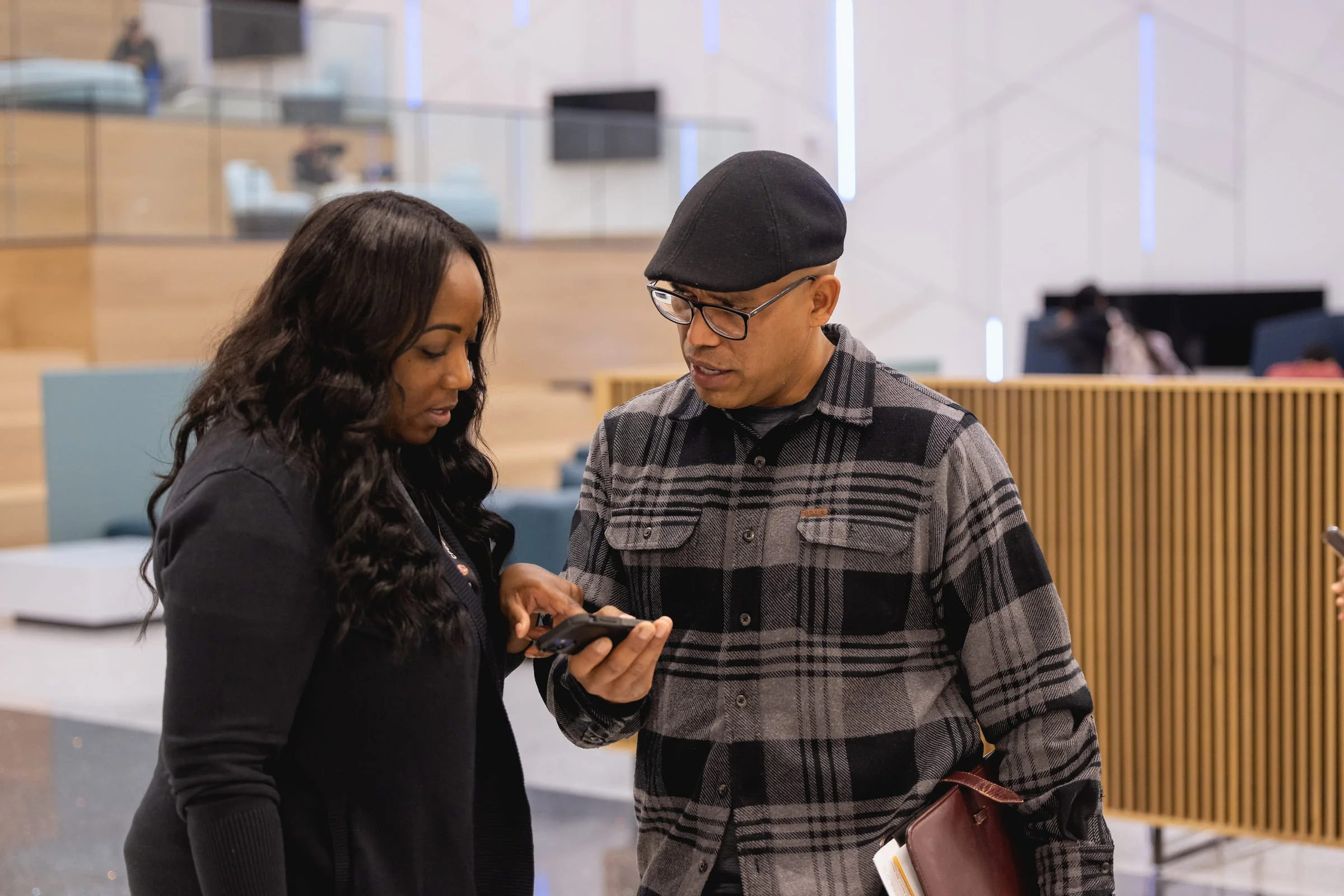 Navigator helping a student with something on a phone