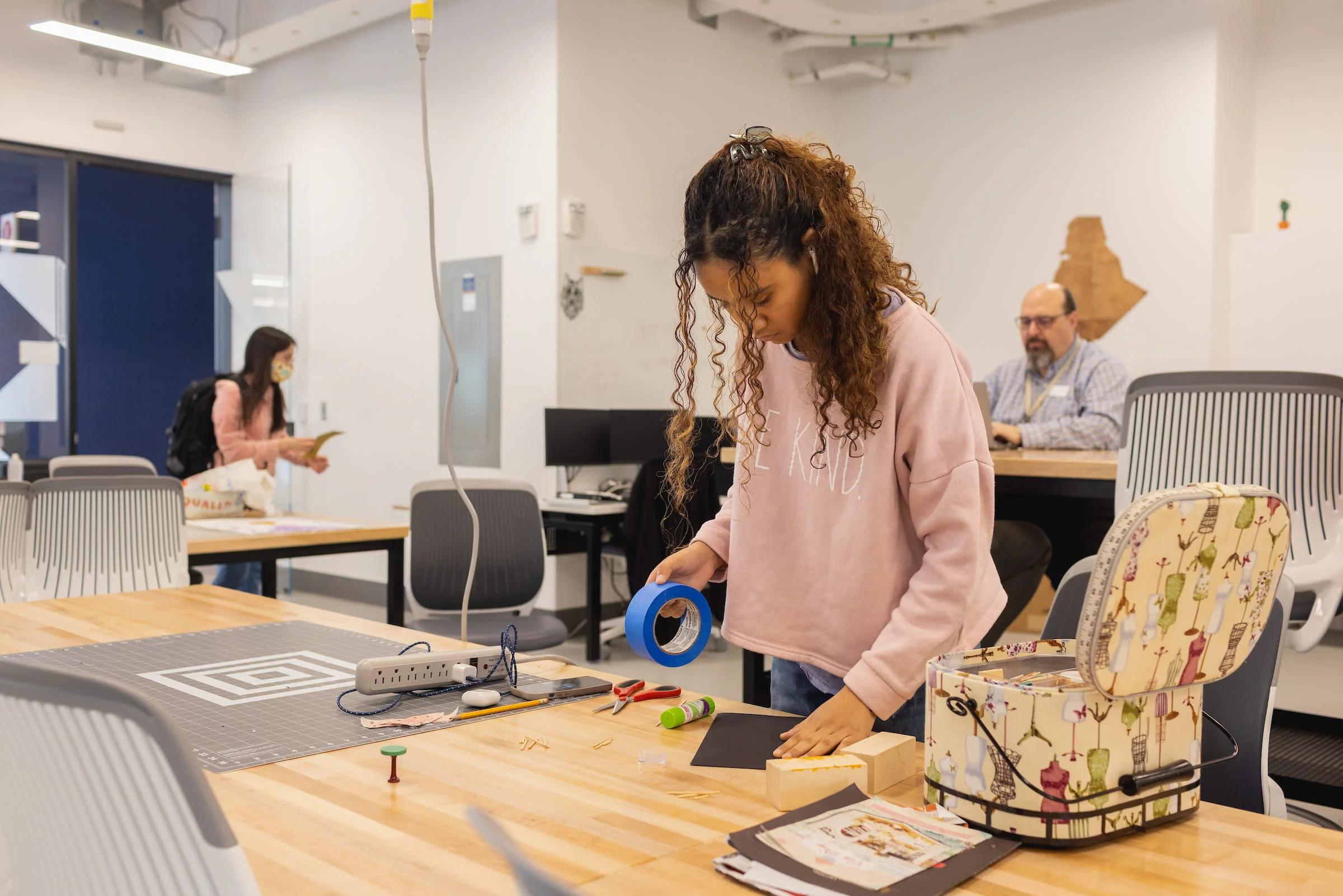 Student working on a project at a makerspace bench