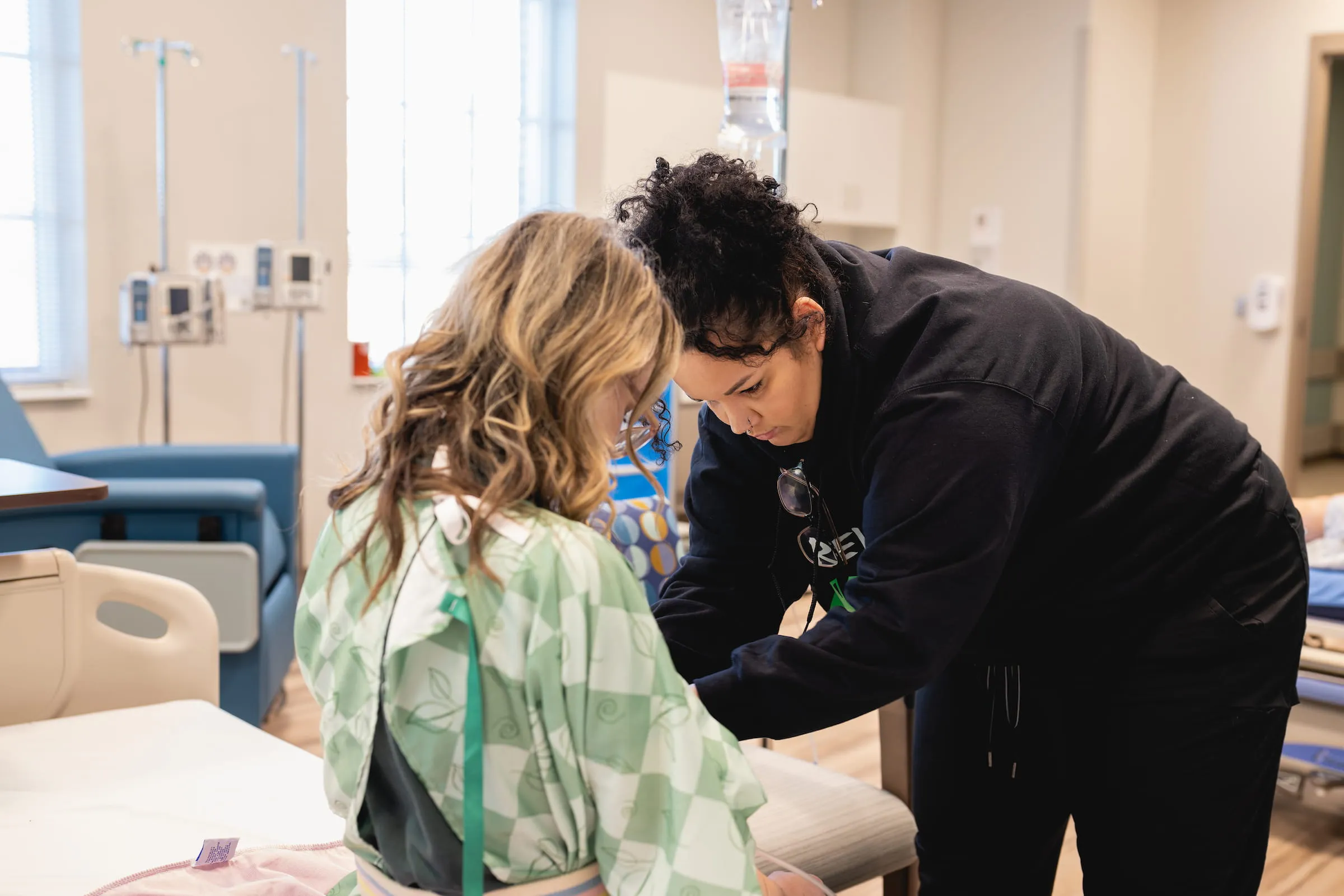 Clinician examining a patient in a clinic room