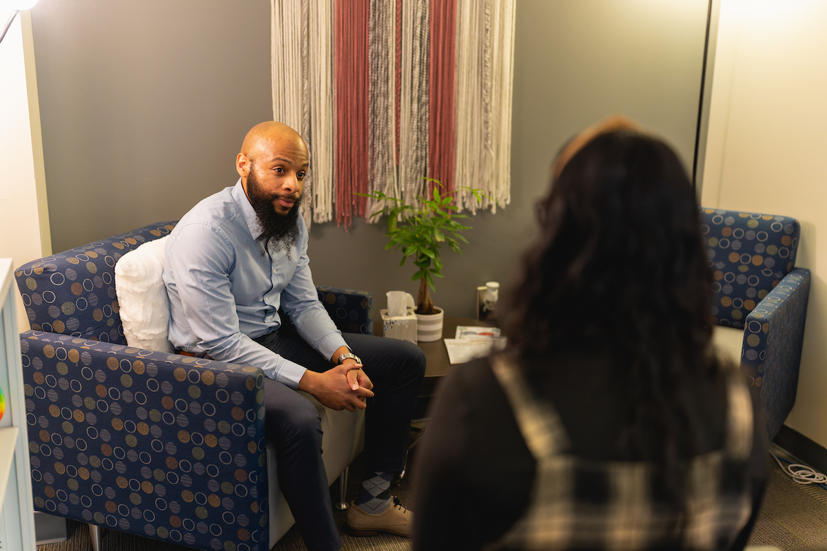 Counselor meeting with a client in a counseling space