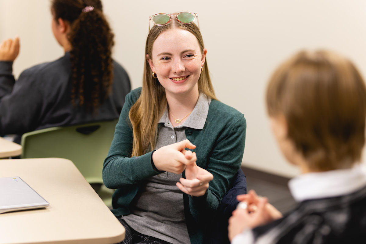 Student conversing in sign language