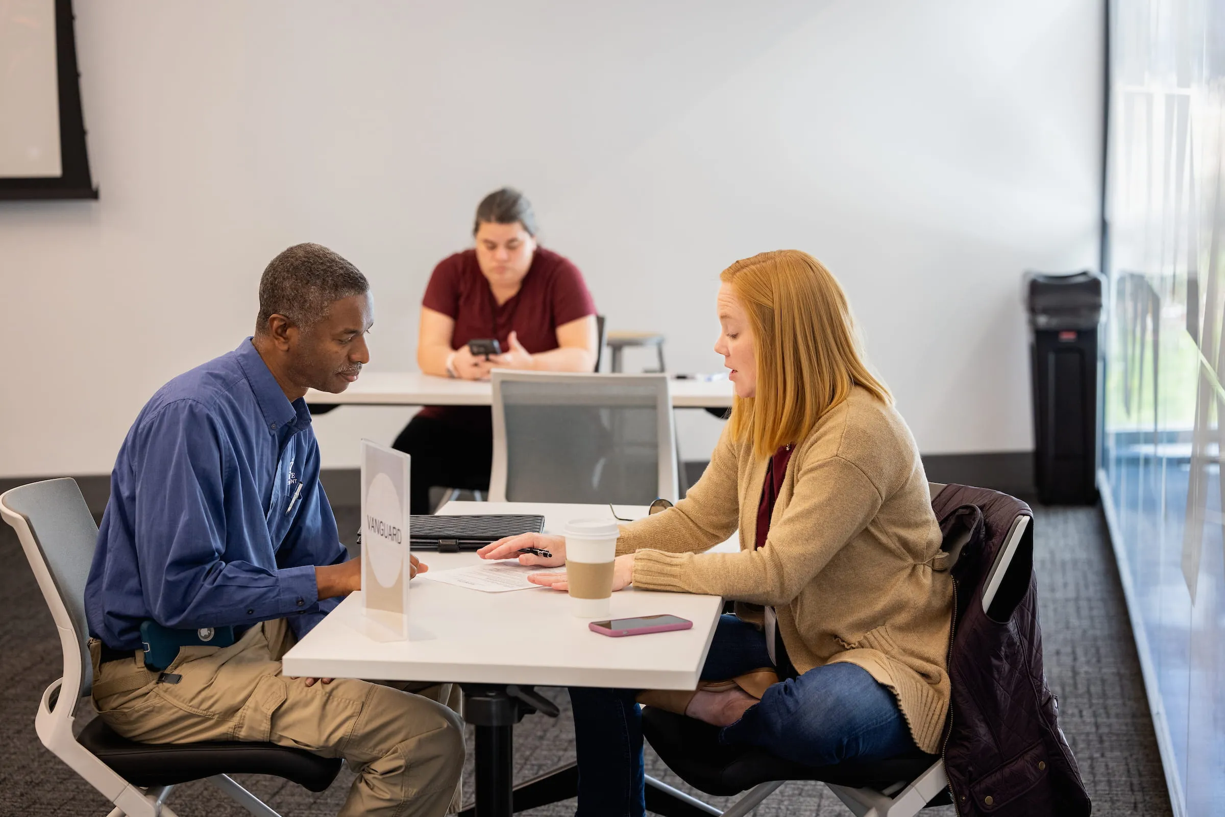 Adviser talking with a student across a table