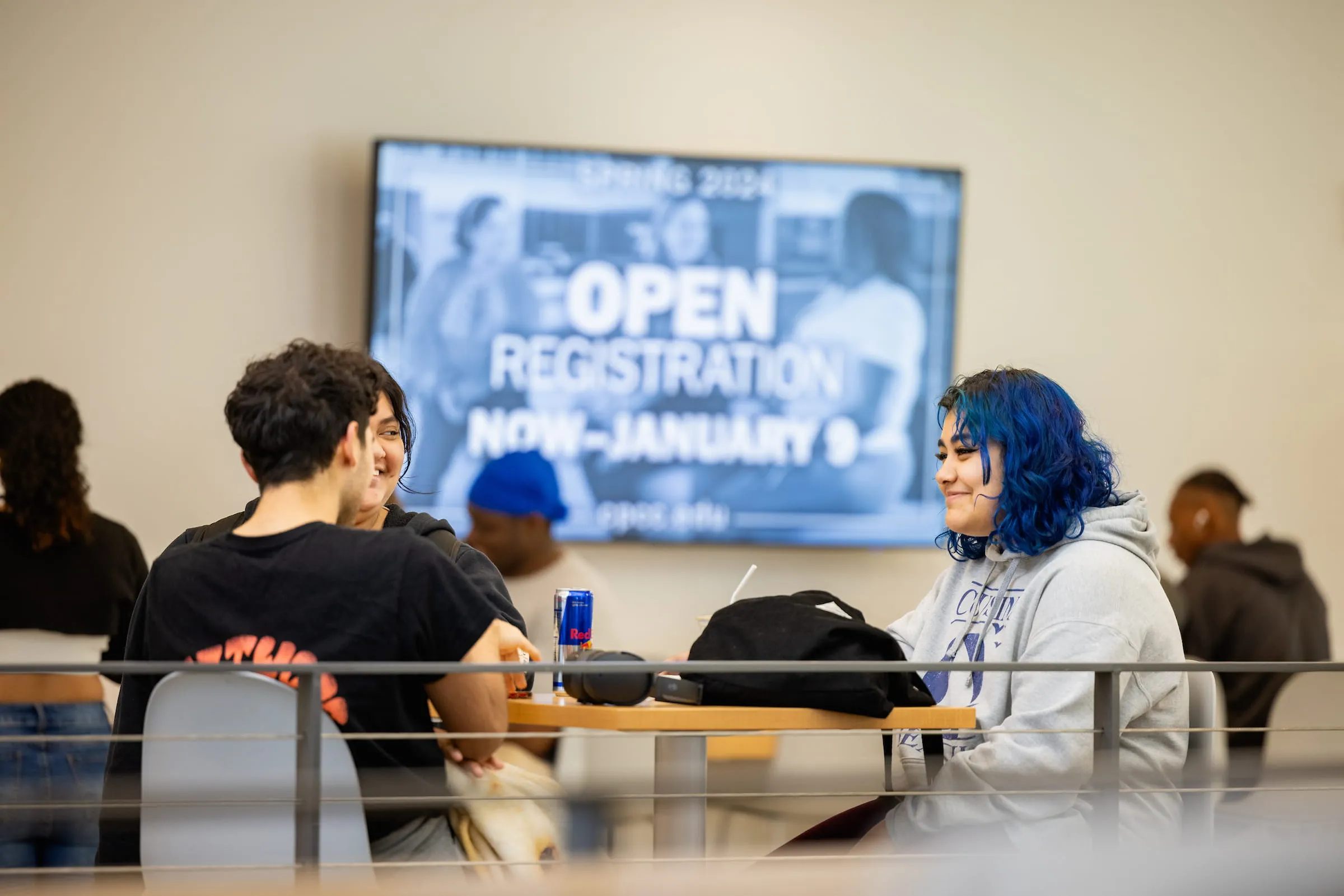 Students seated in front of an open registration announcement screen