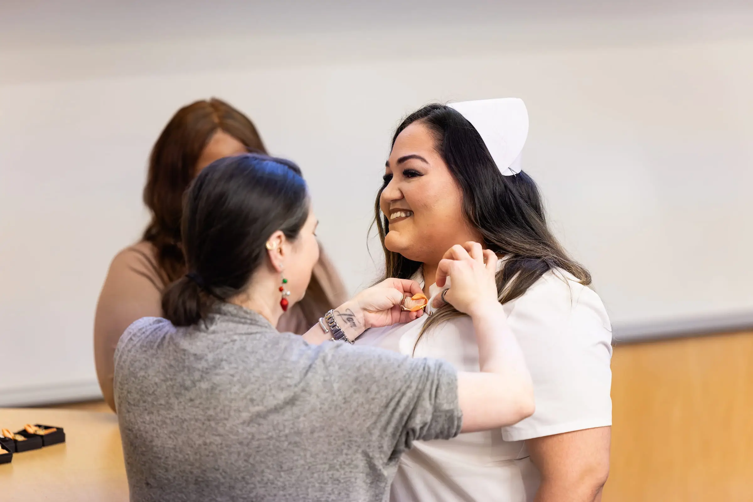 Surgical technology graduate being pinned at the ceremony