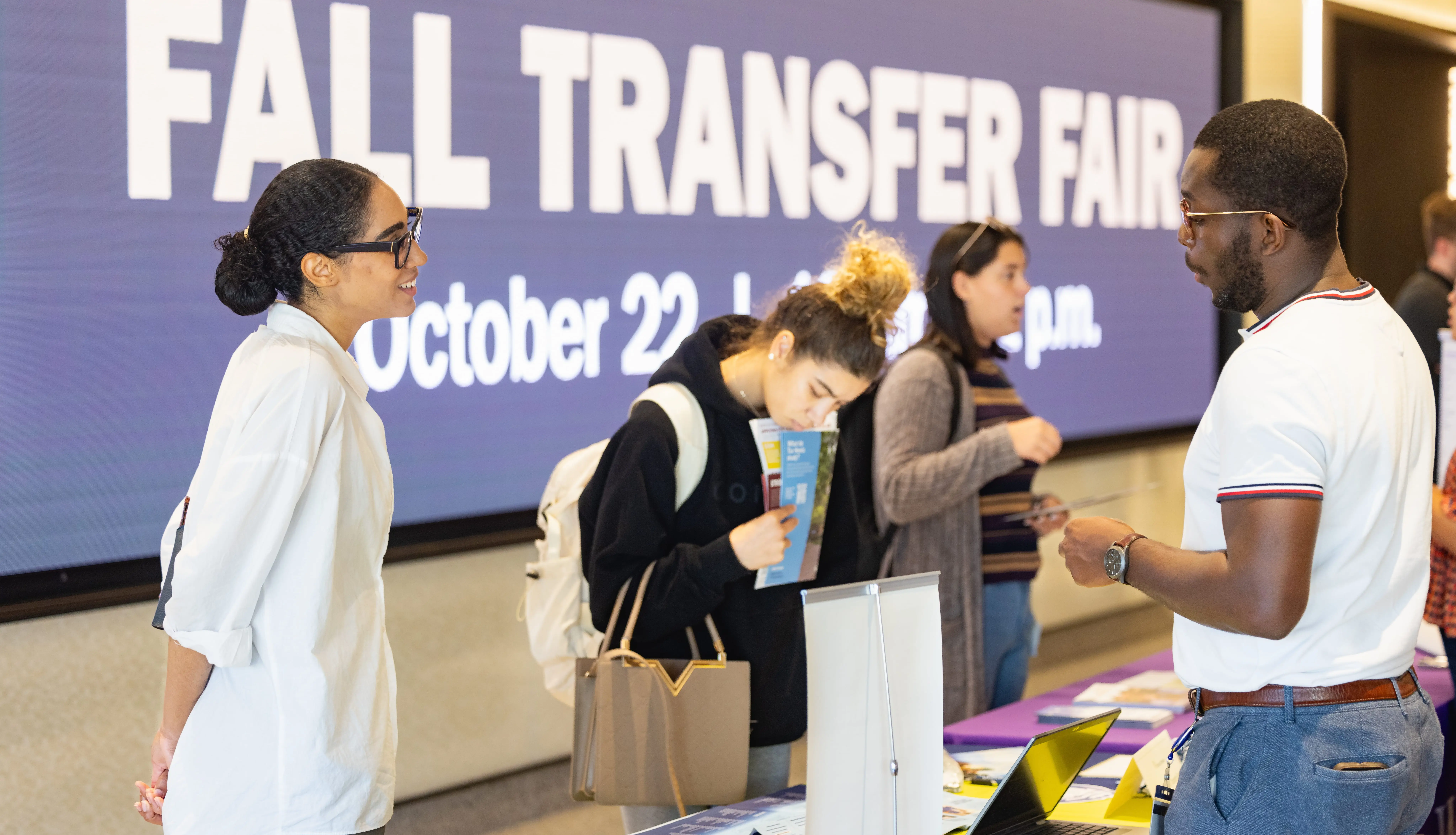 Students browsing tables at the Fall Transfer Fair