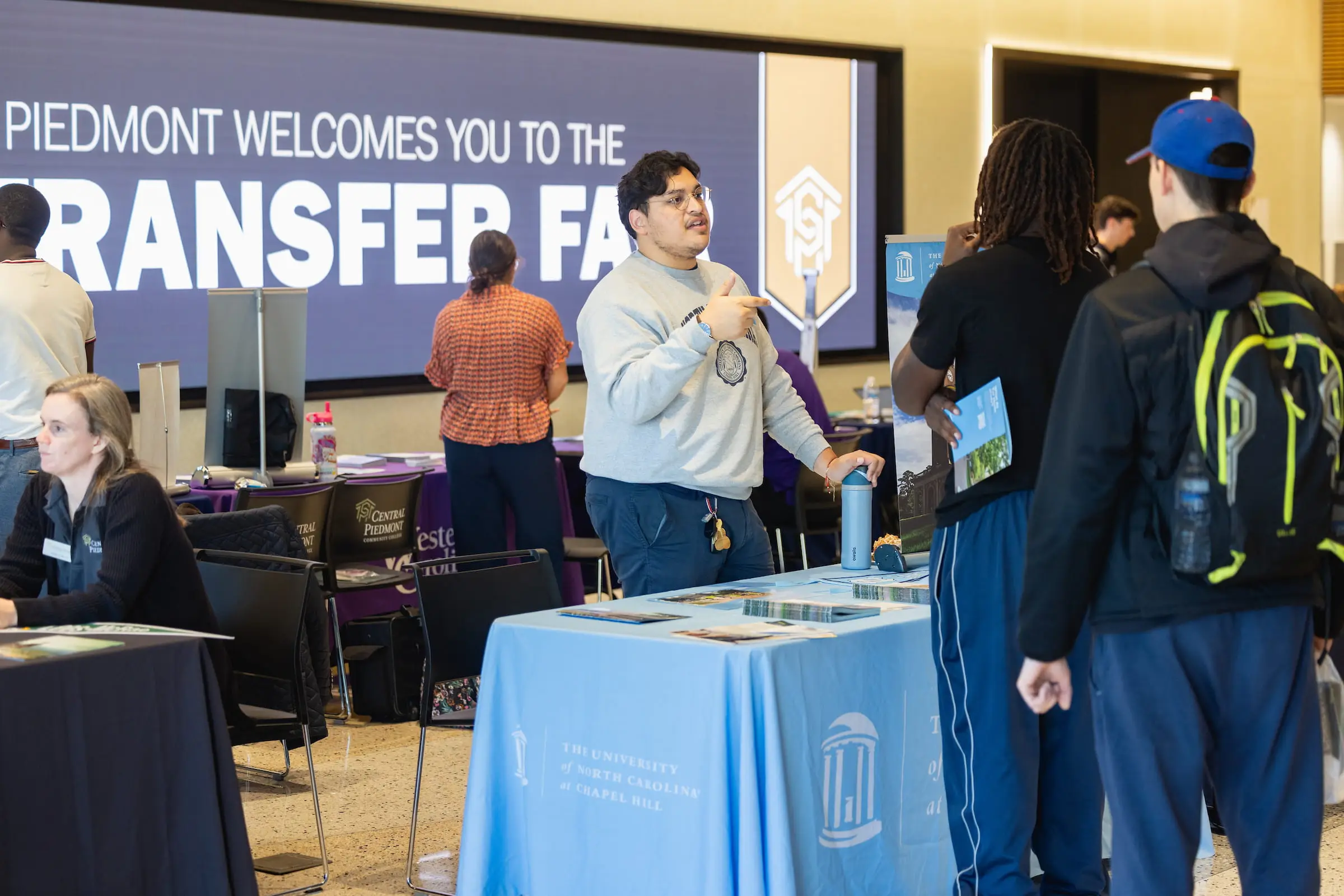 Students visiting university tables at the transfer fair