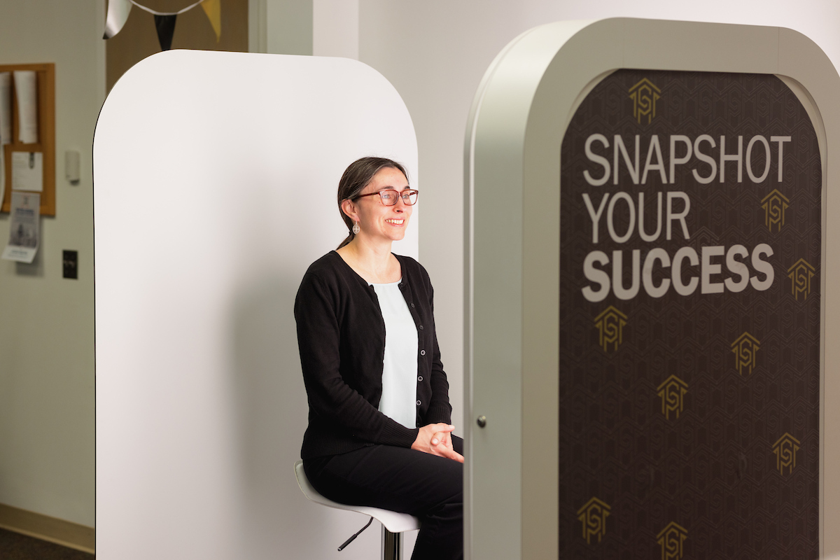 Student seated in the headshot photo booth.