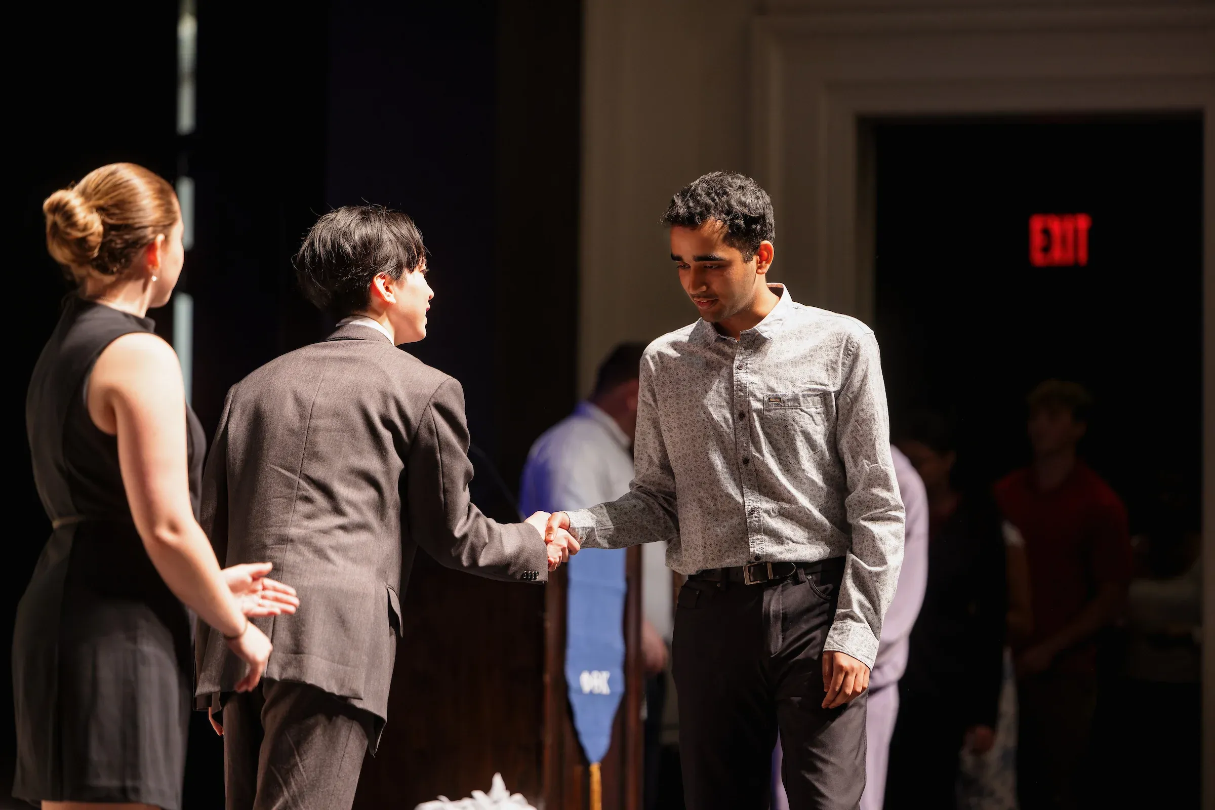 Students shaking hands with employers at a hiring event