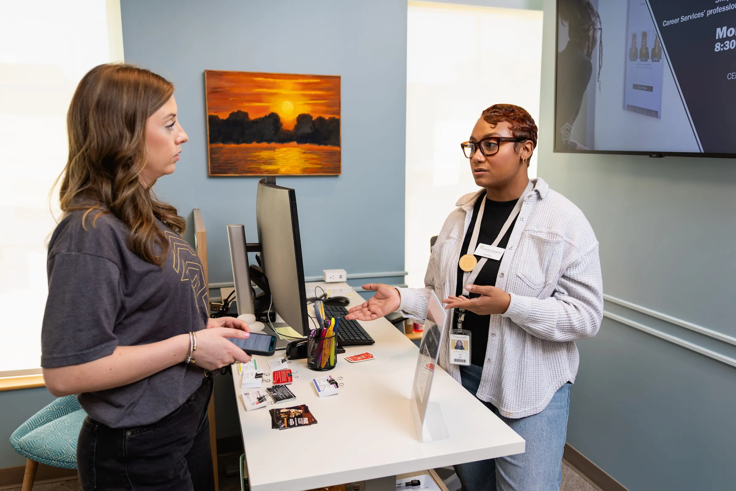 Patient checking in with staff at the virtual primary care clinic desk