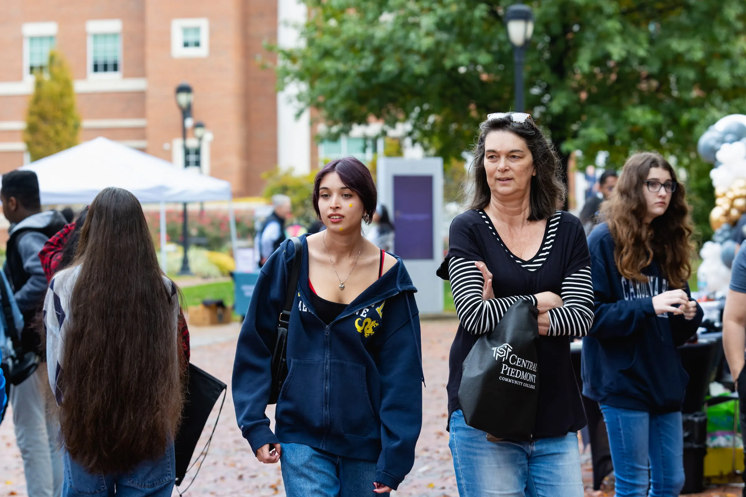Students walking together across campus during an outdoor event