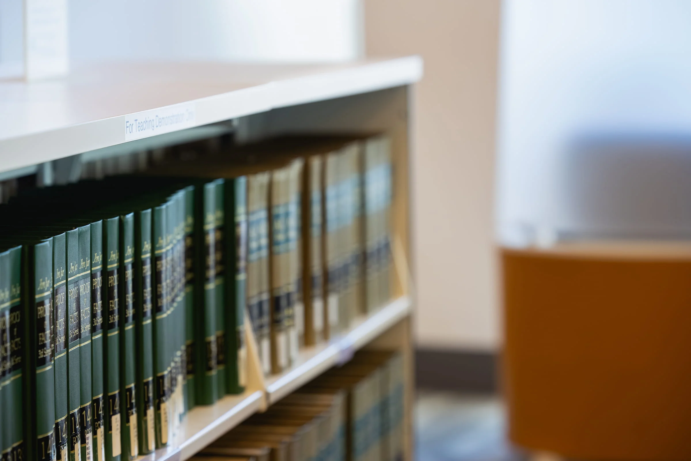 Row of bound volumes on a library shelf