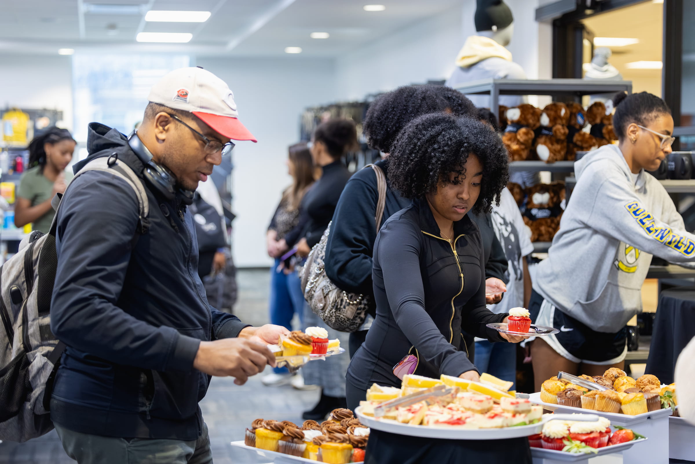 Students serving themselves from platters of food at a campus dining counter