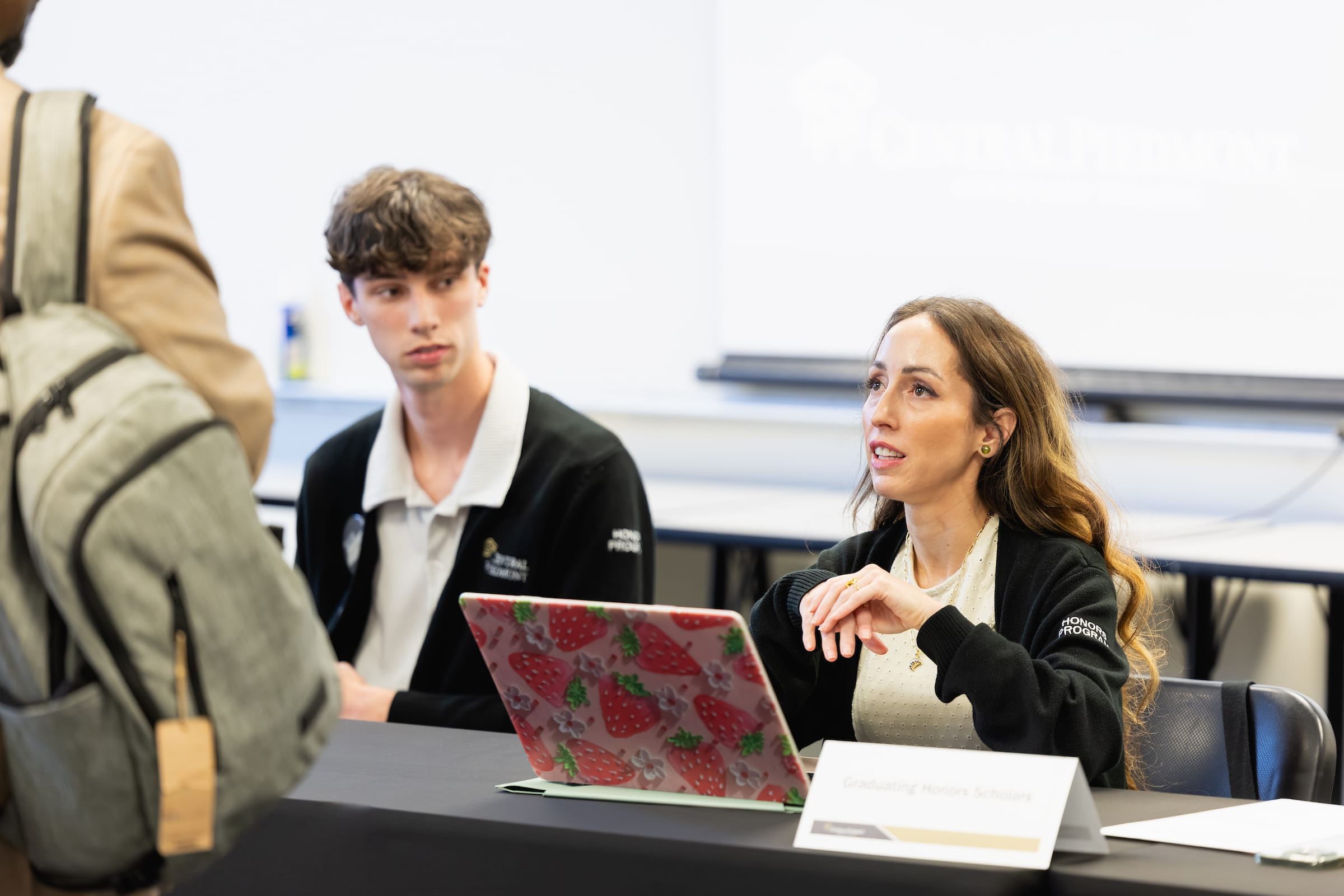 Adviser talking with a student across a table during registration