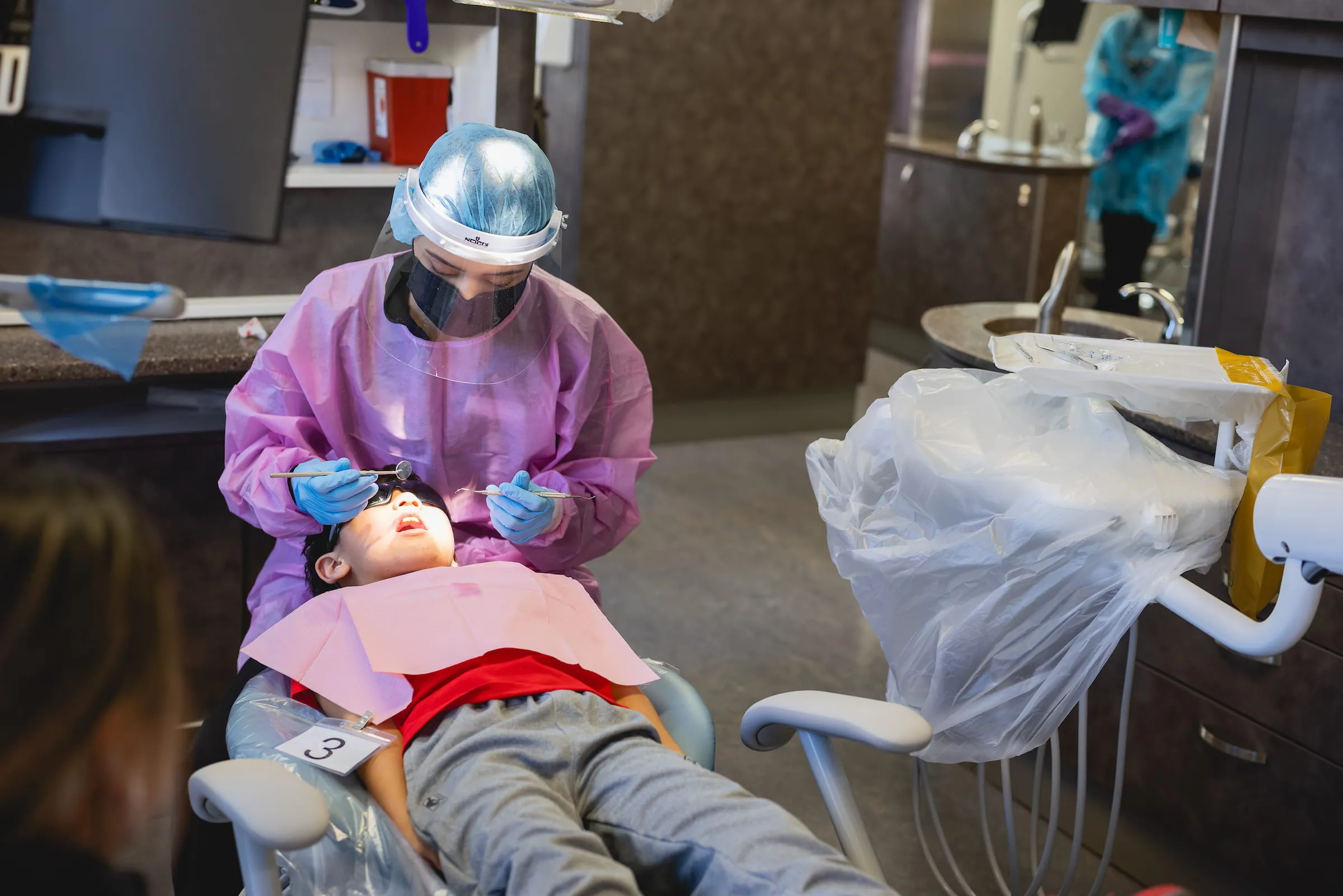 Dental student practising on a training mannequin in the clinic