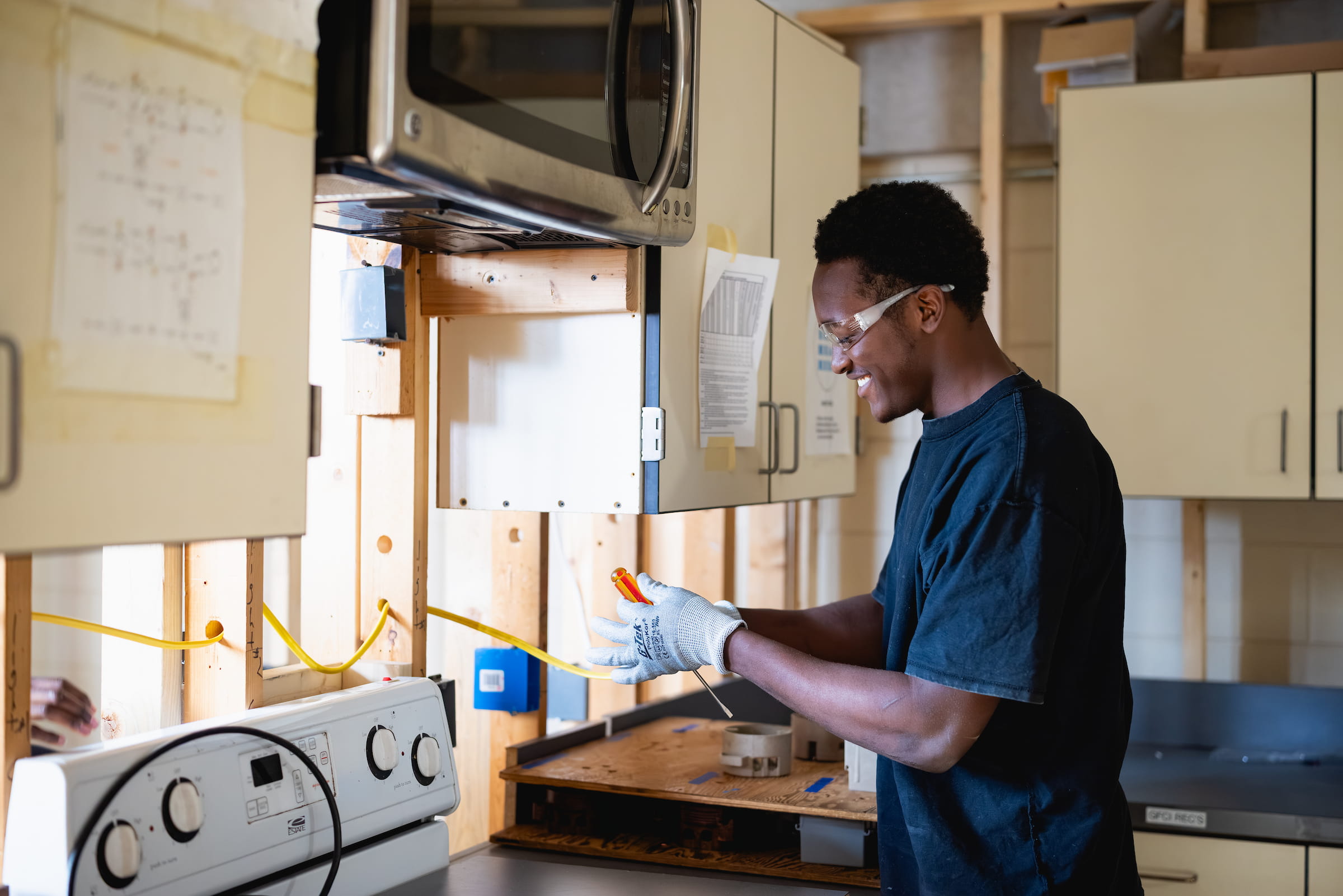 Electrical systems student wiring a panel in an appliance training lab
