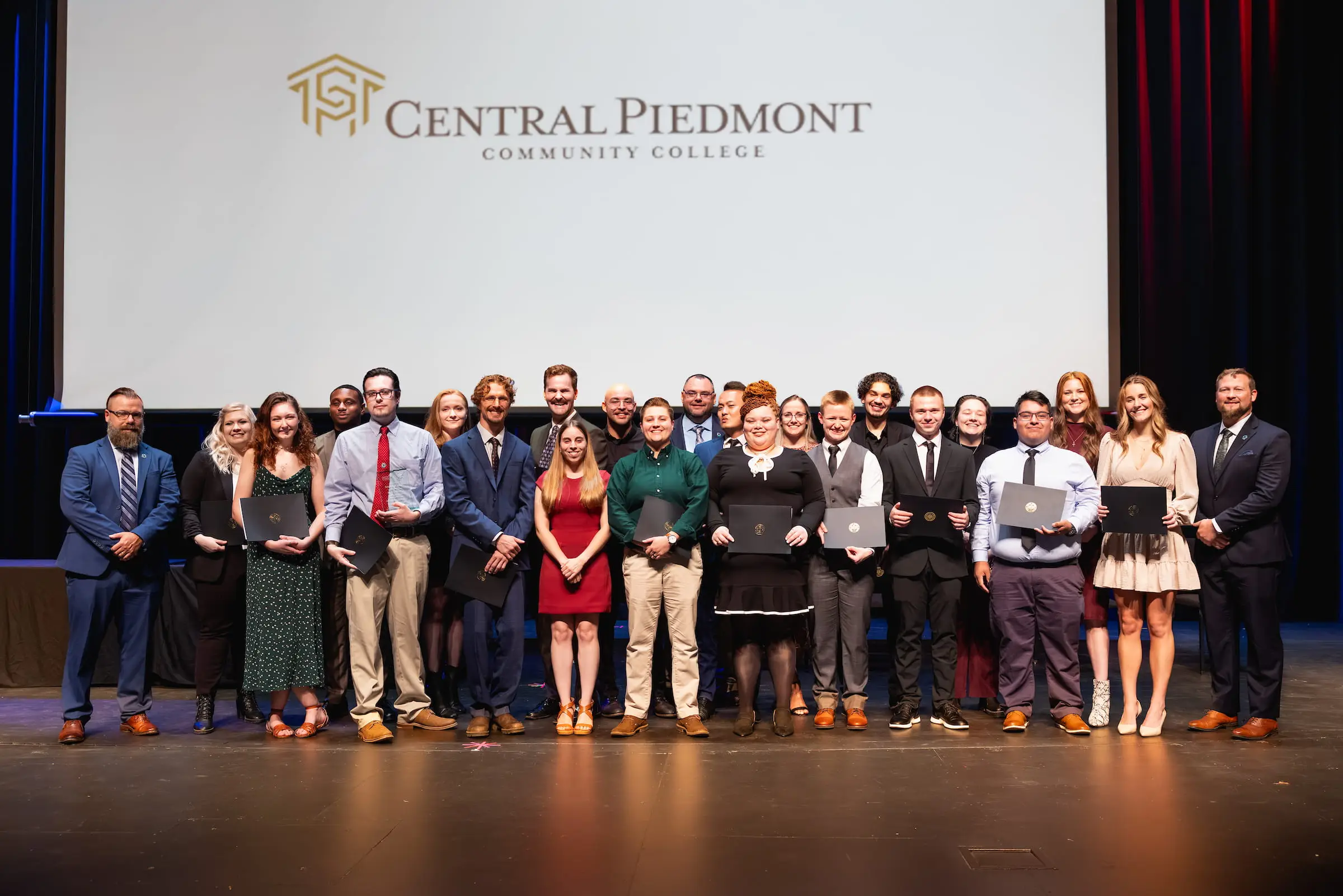 Group of award recipients on stage at a Central Piedmont ceremony