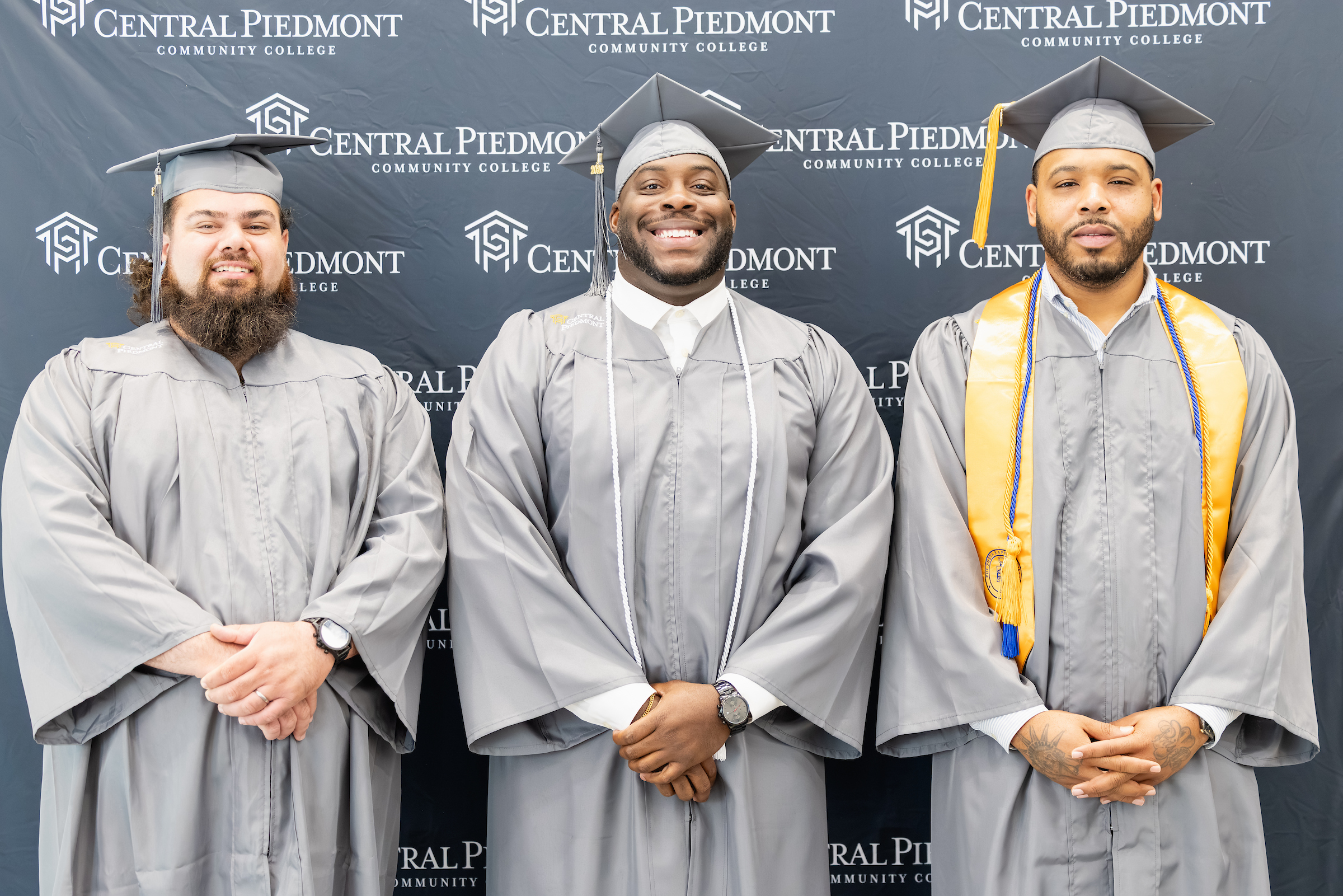 Three Central Piedmont students at commencement in May 2026