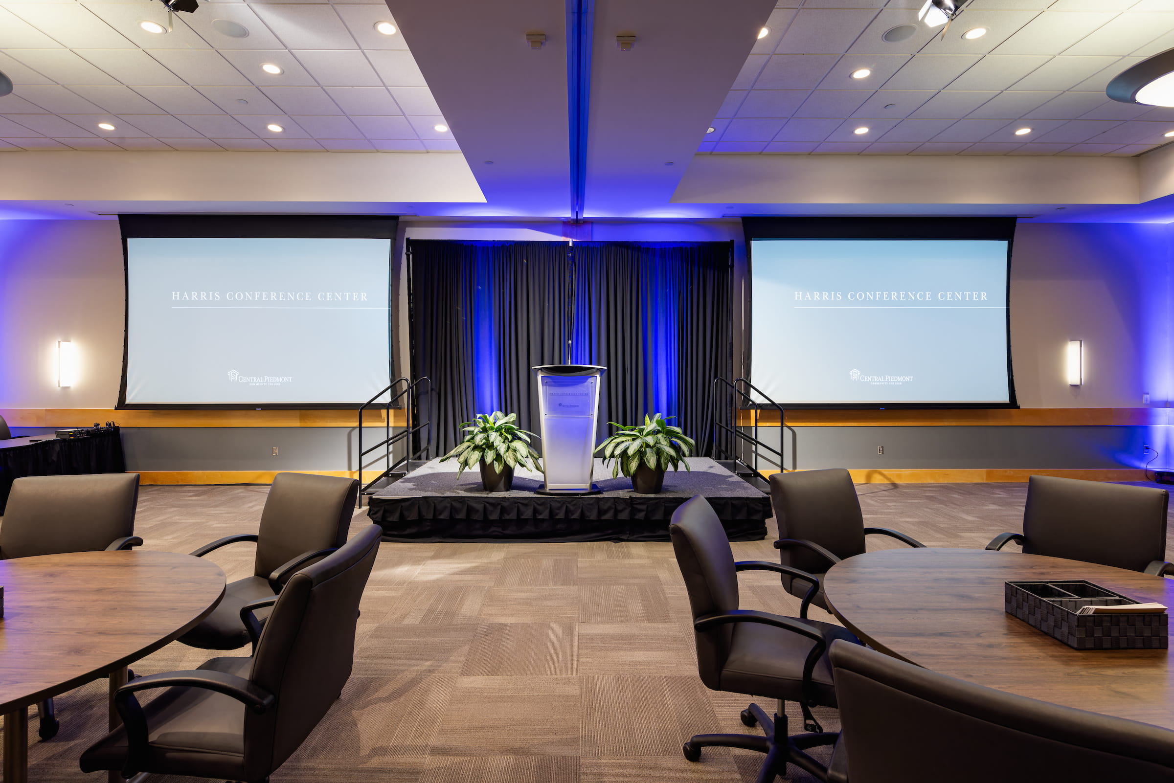 Conference room at the Harris Conference Center set up with a lectern and screens