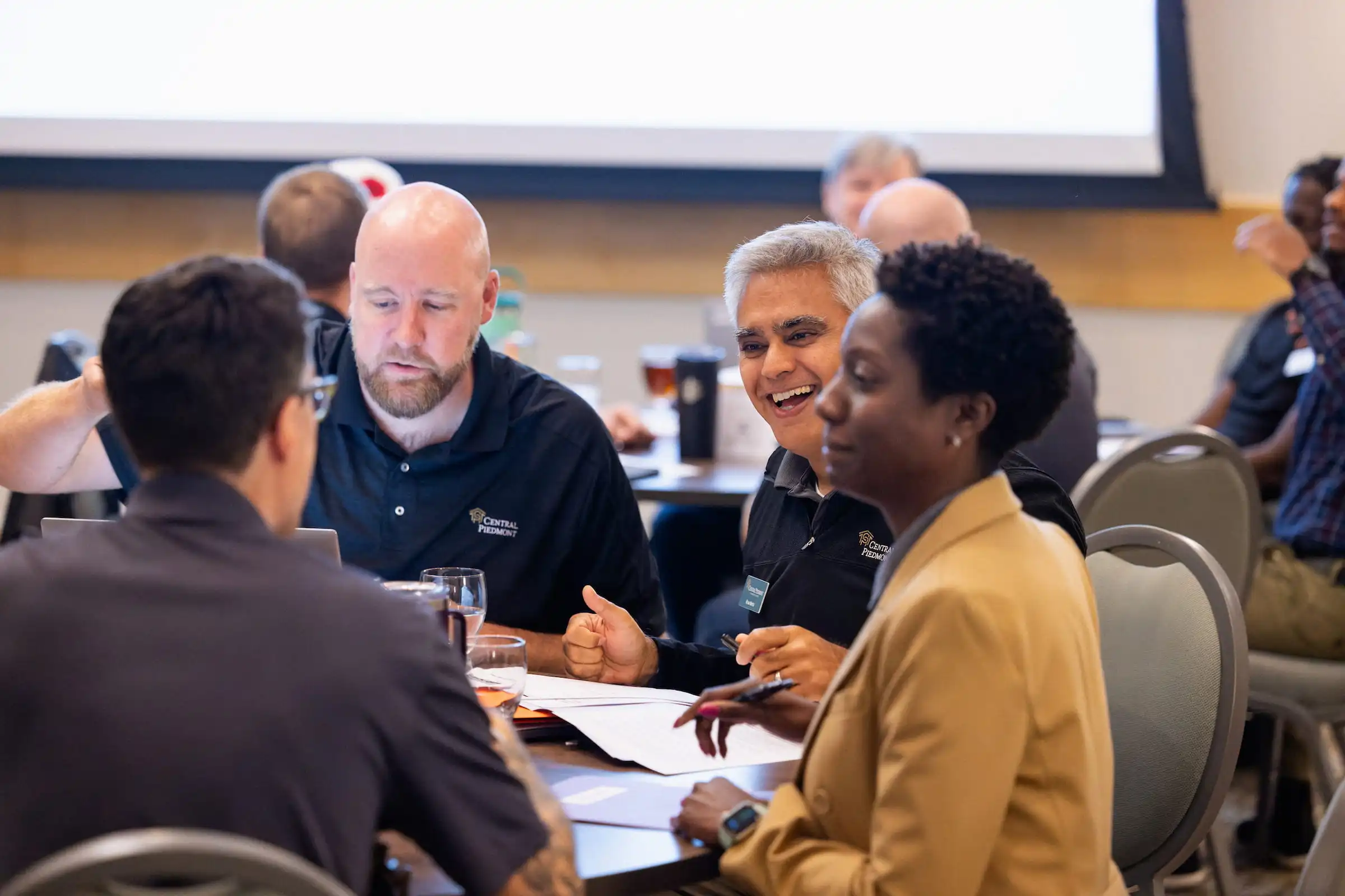 Central Piedmont staff working with a client group around a table