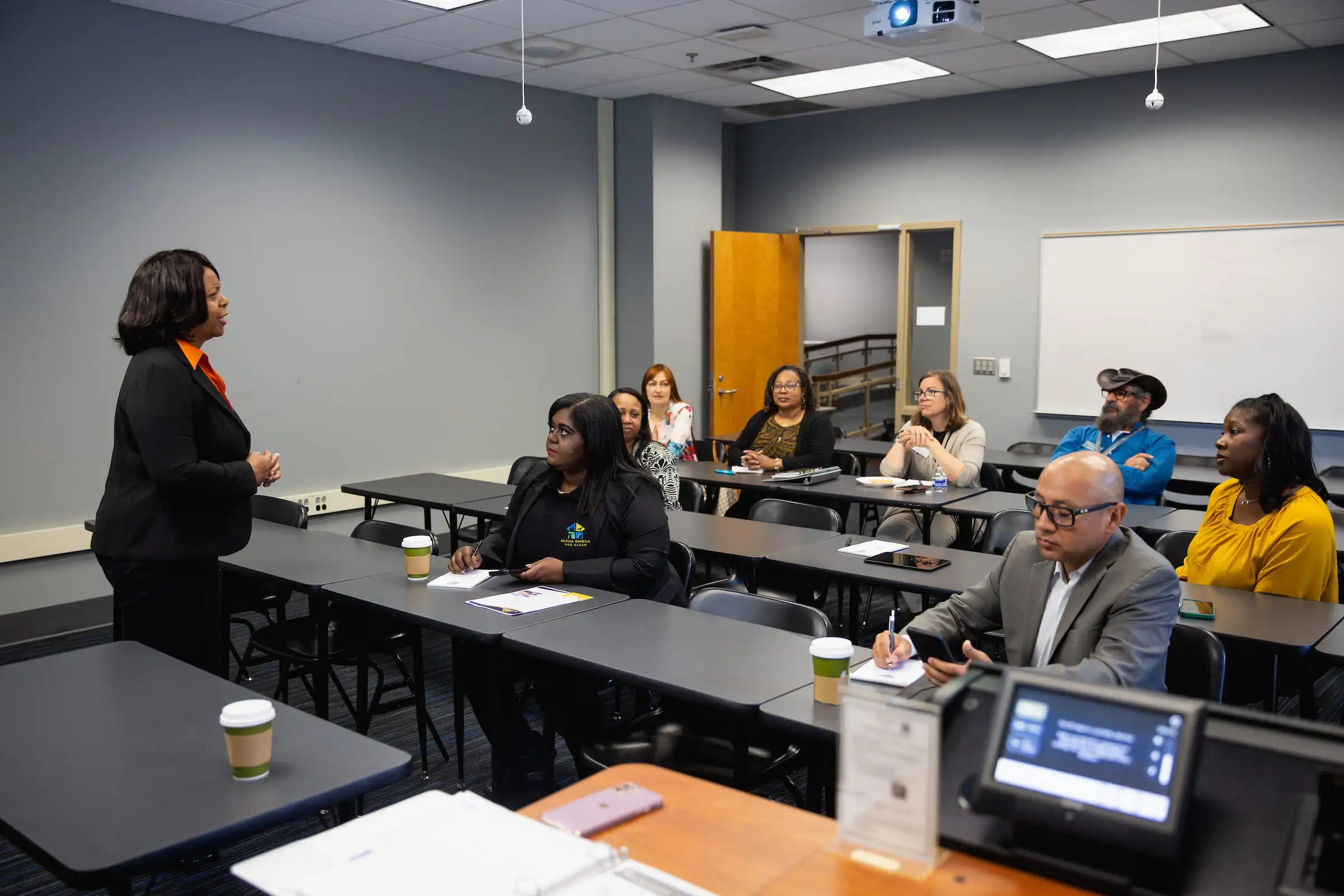 Presenter leading a training session for seated participants
