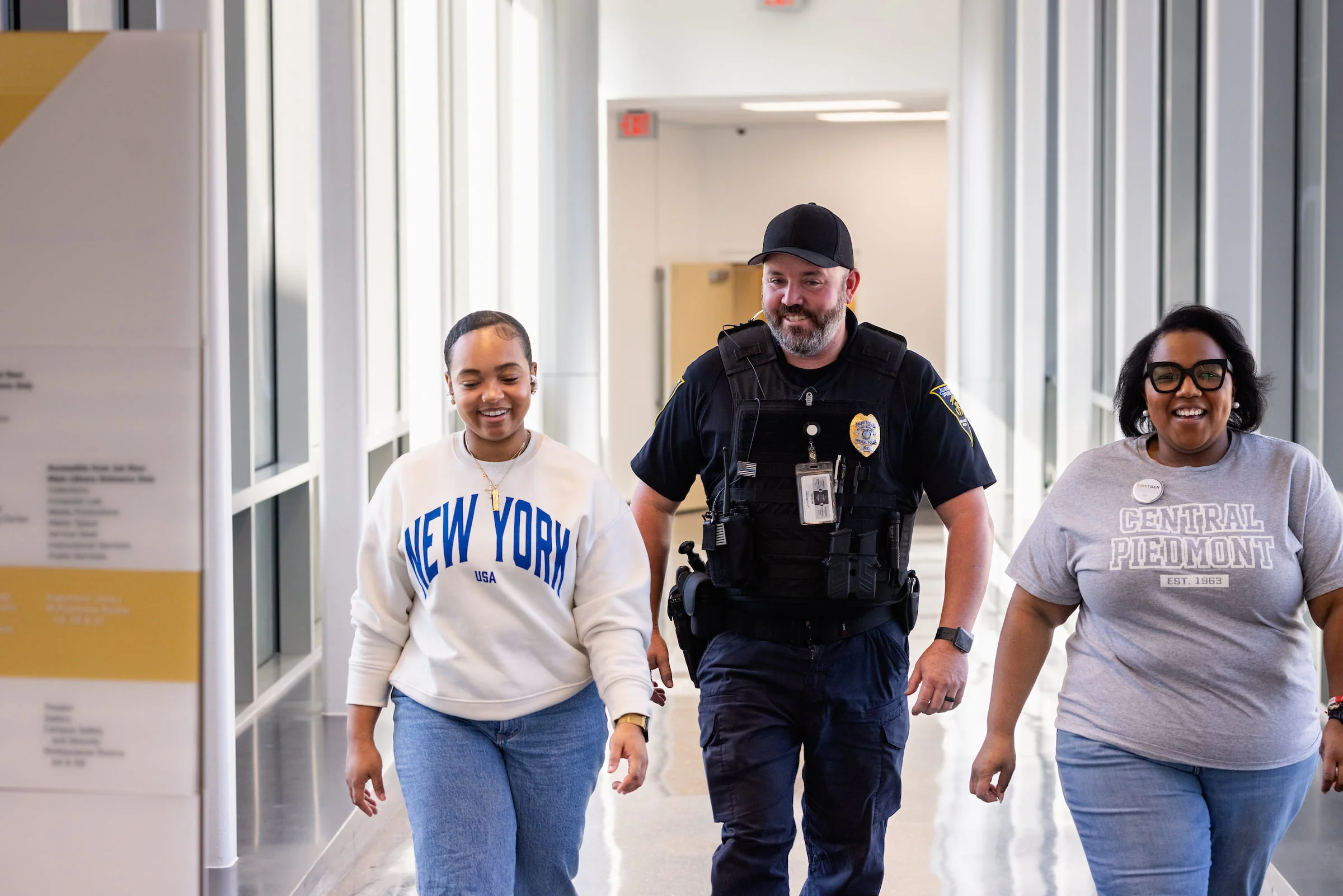 Staff walking with a campus security officer along a corridor