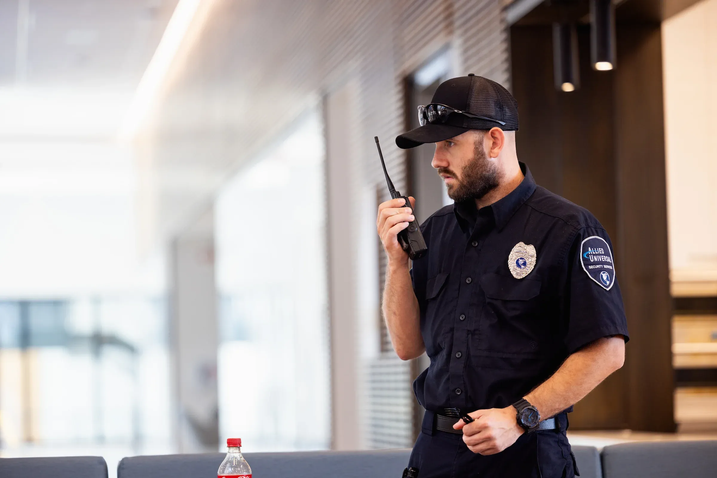 Campus security officer using a radio in a corridor