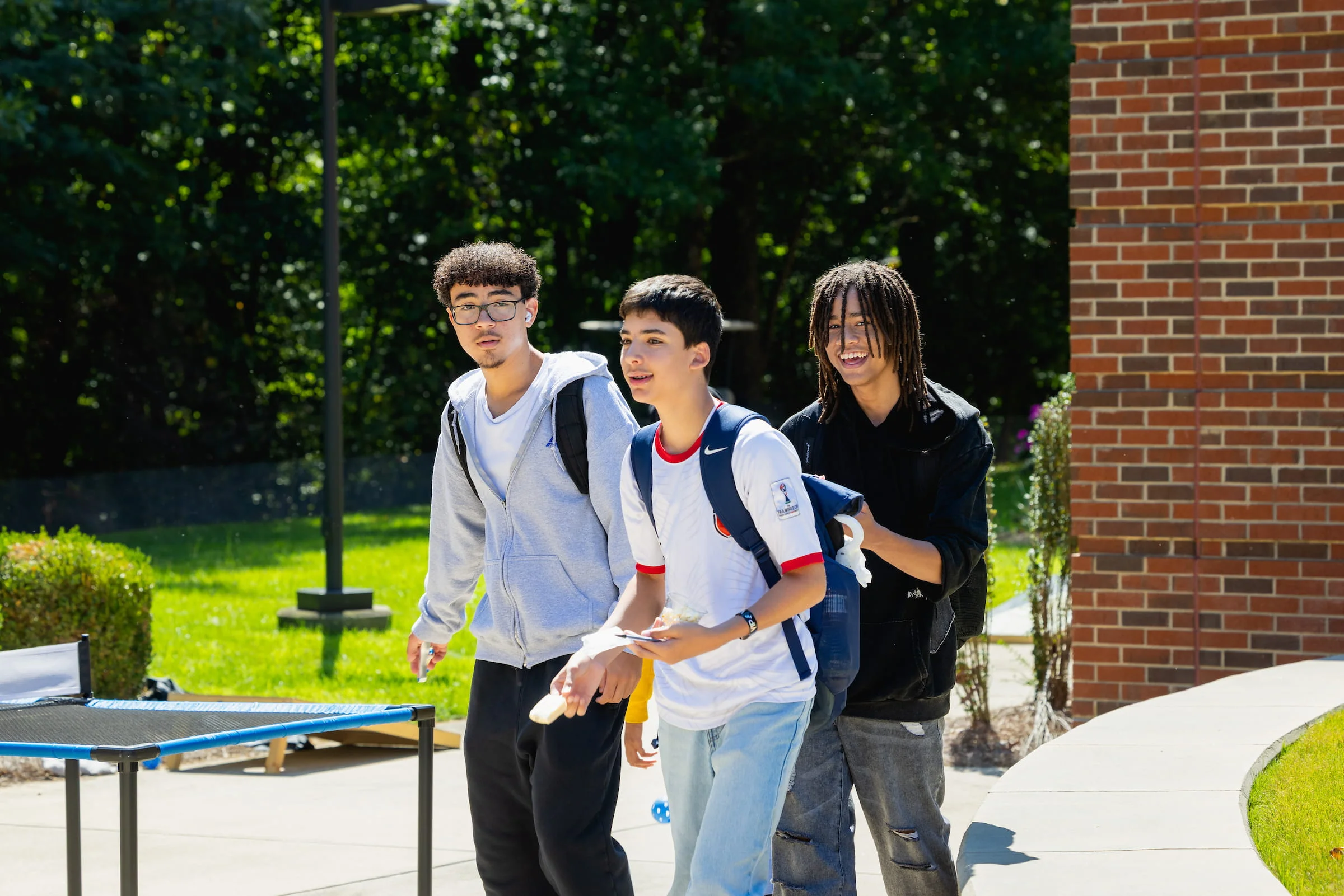 Three Summer Bridge students walking across campus