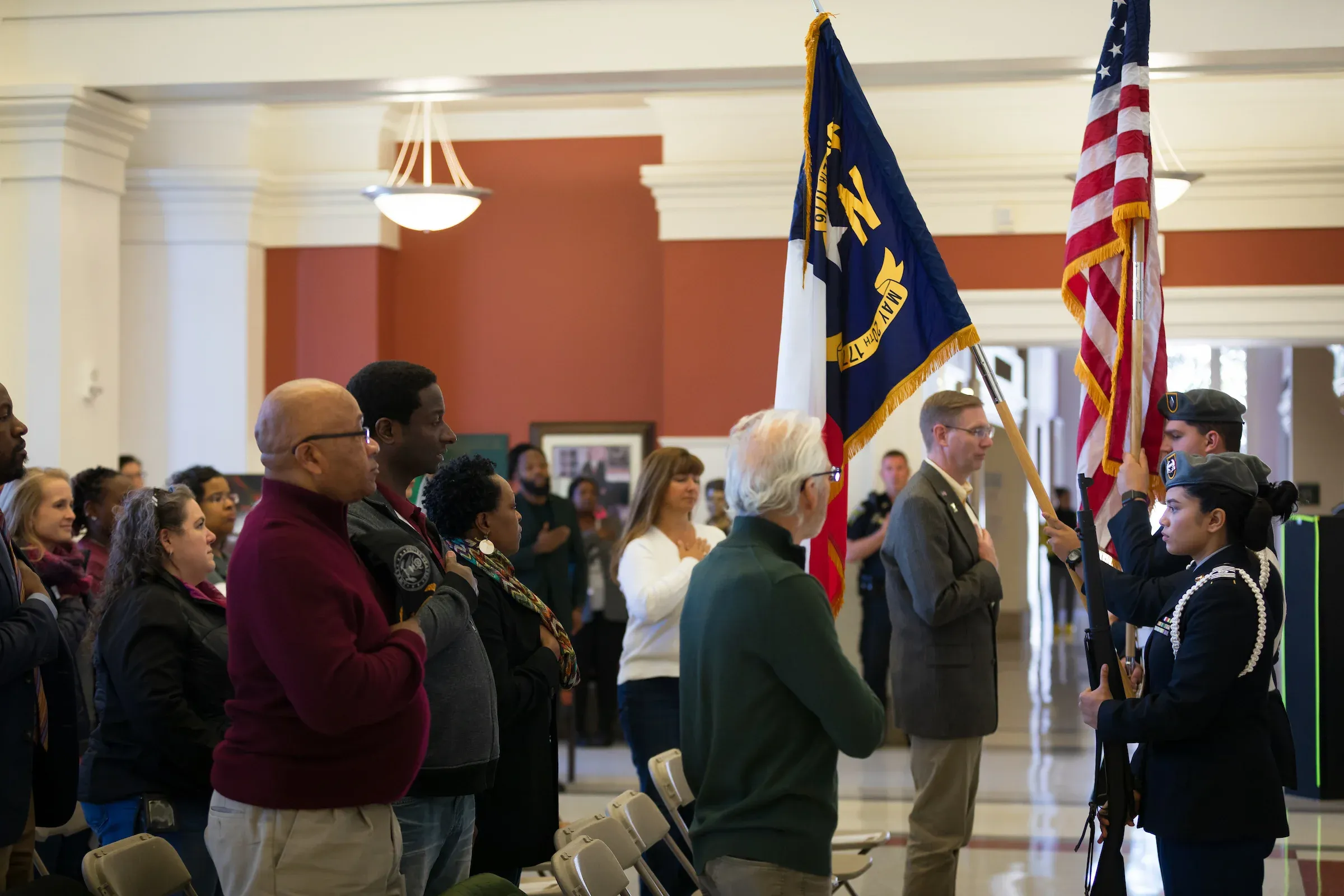 Colour guard carrying the North Carolina and United States flags at a ceremony