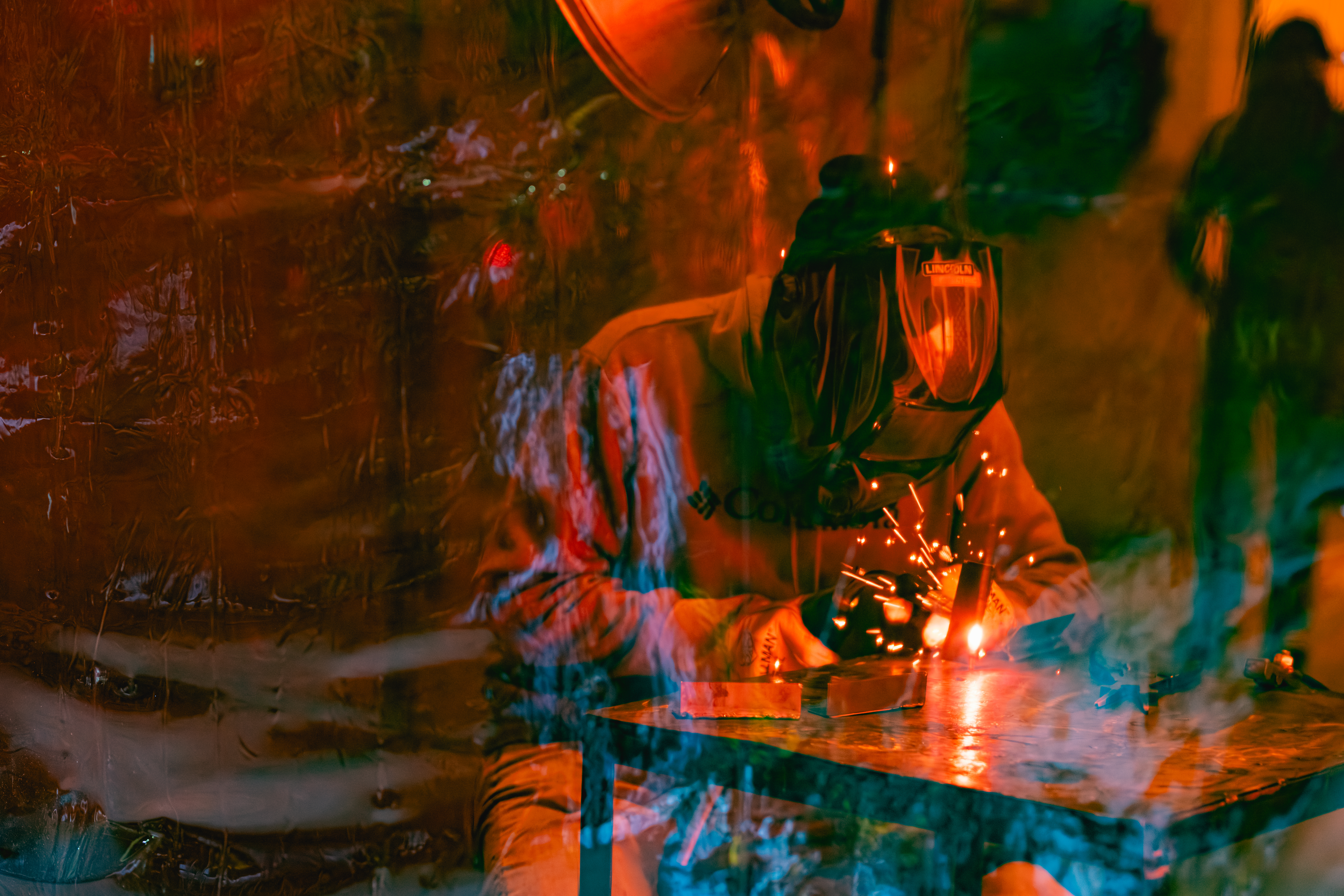 Sparks flying from a welding torch in a darkened workshop