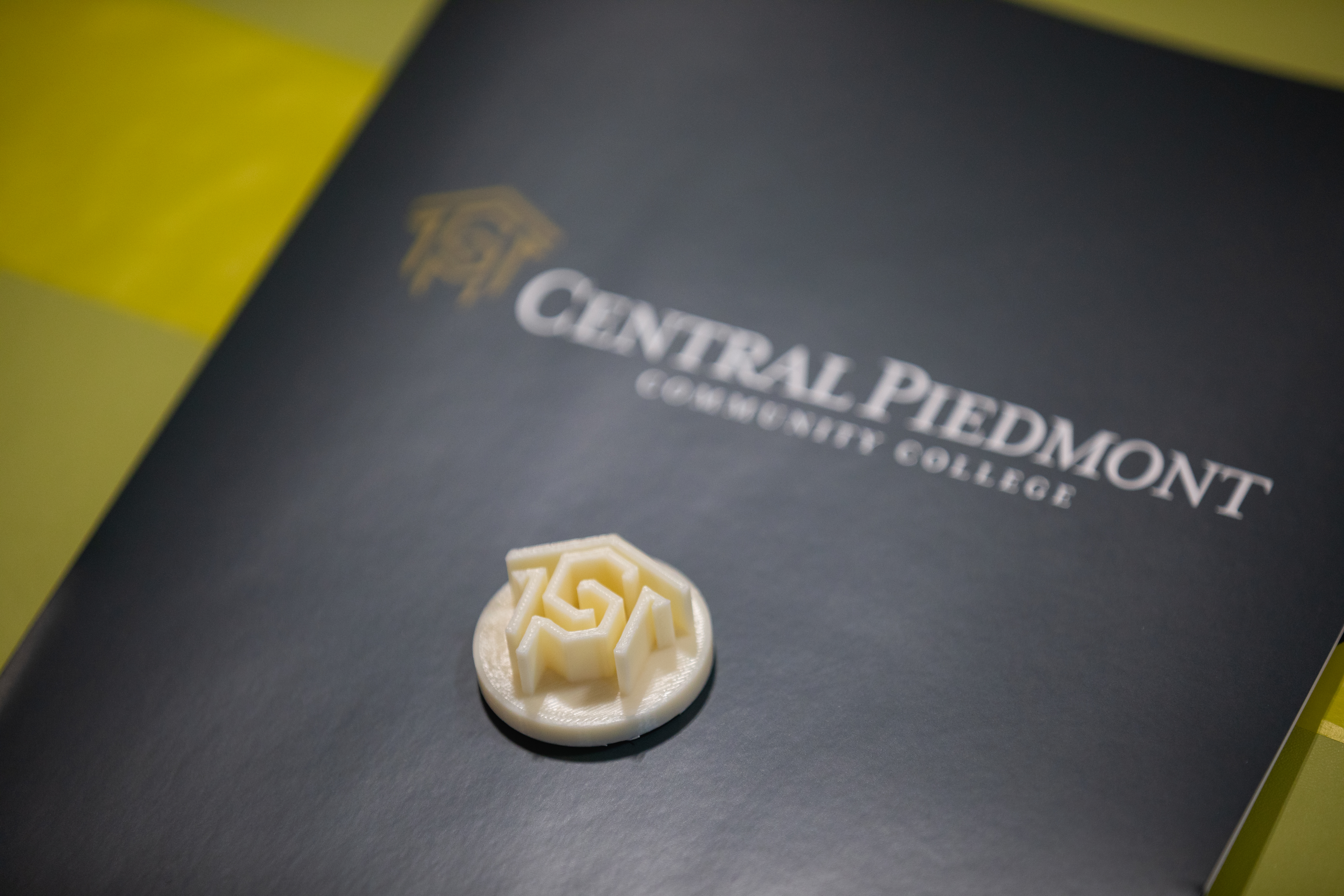 black folder with central piedmont logo