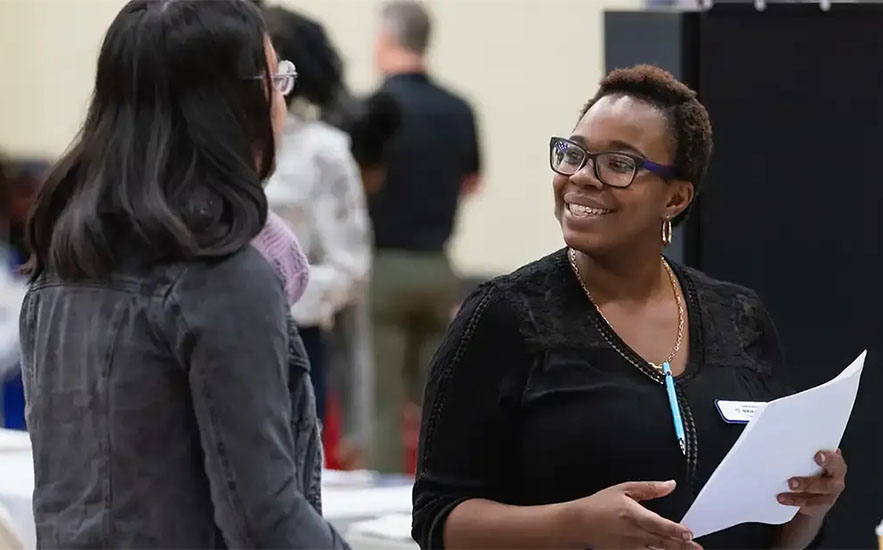 Two individuals interacting at a Central Piedmont event