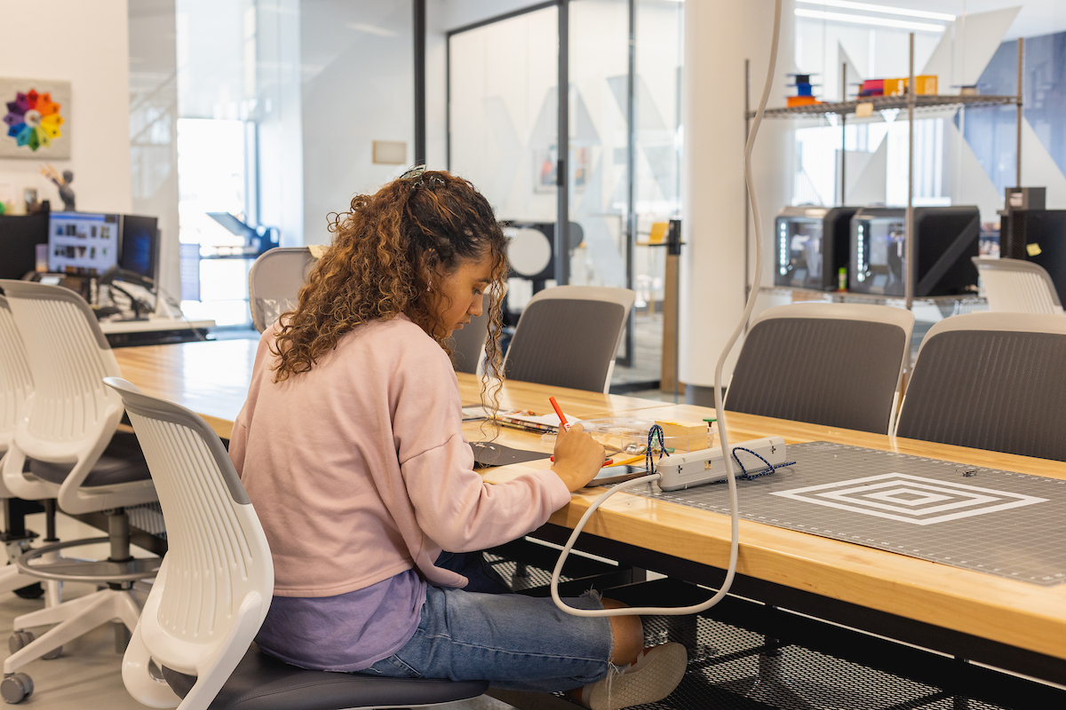 Student creating something in the library's Makerspace