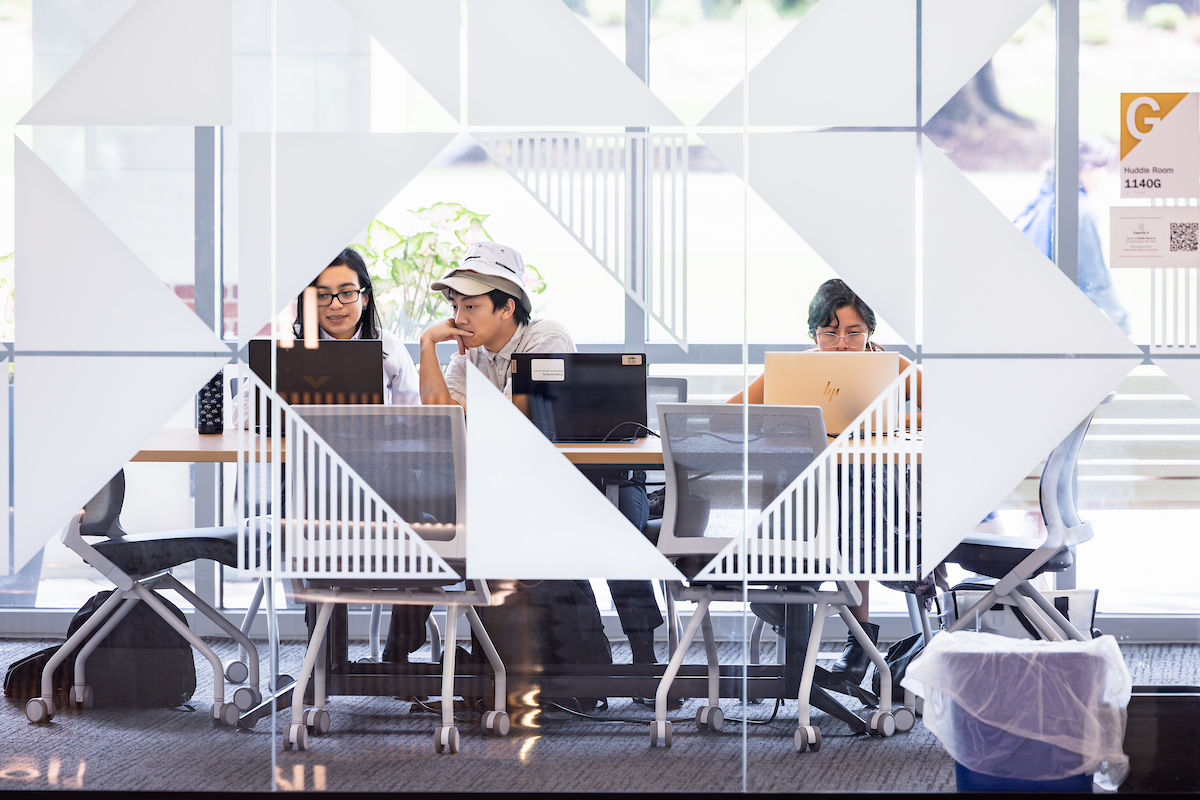 Students seated around a study table in the library
