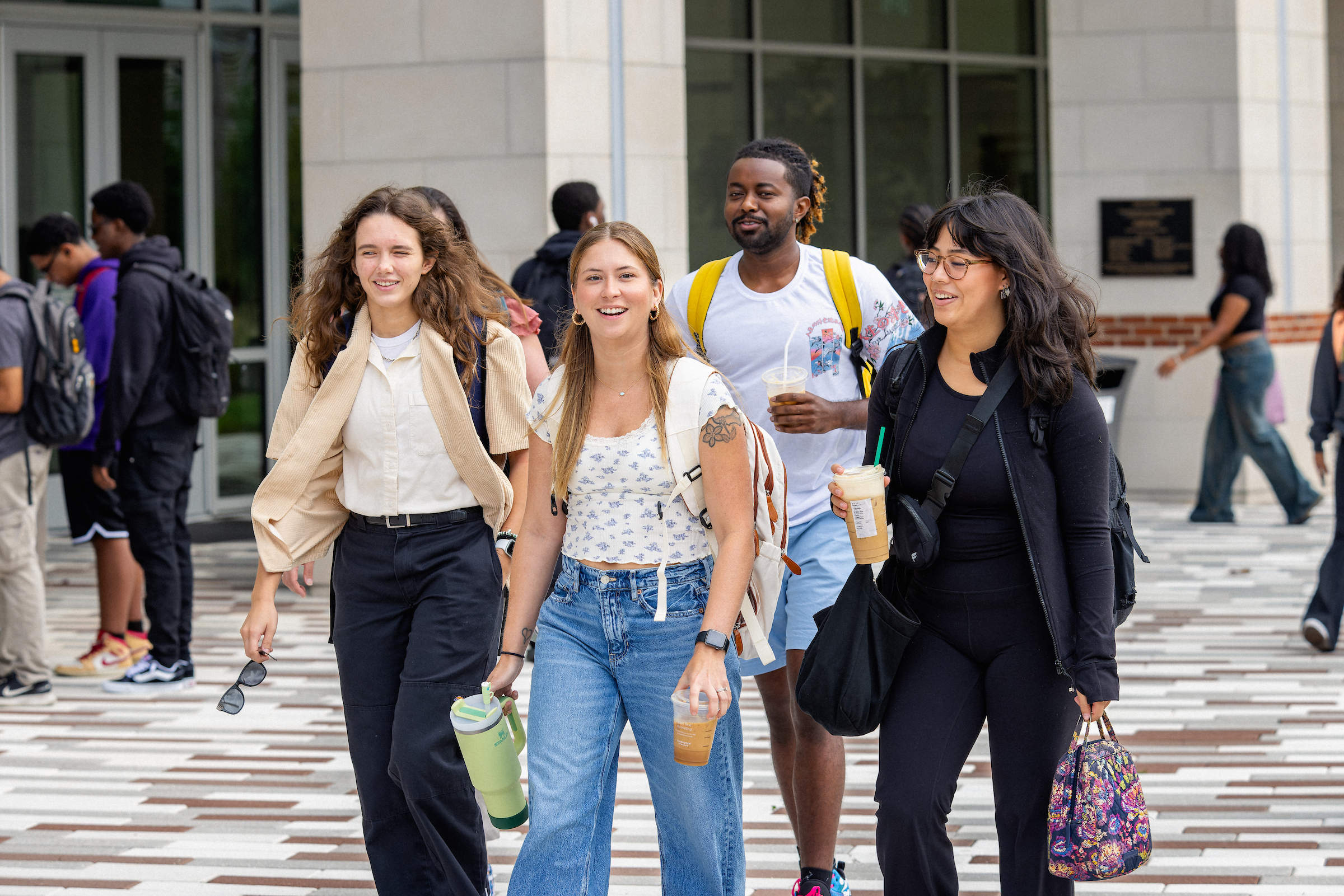 Group of students walking together across campus