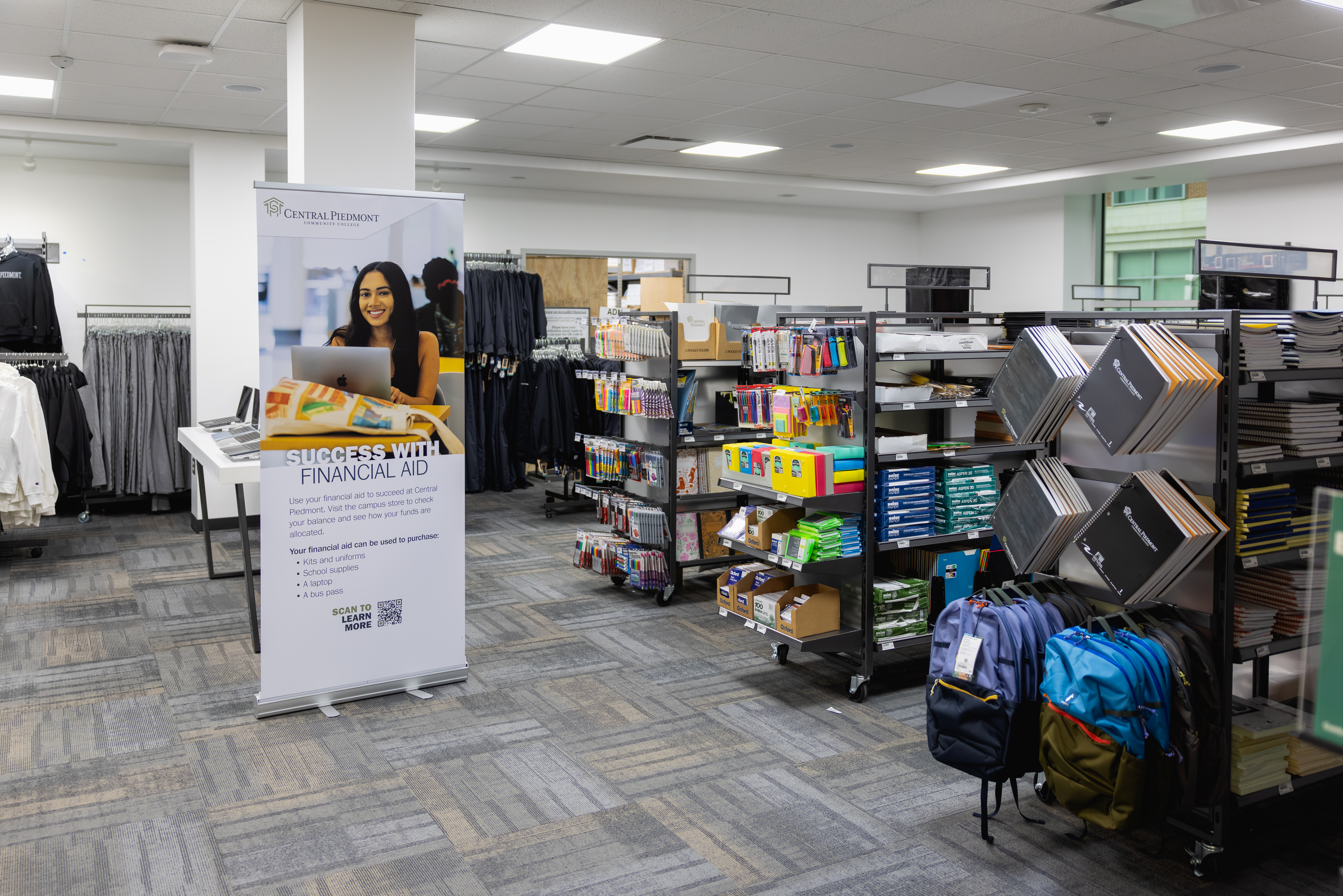 Interior of the campus store showing shelves of school supplies and clothing