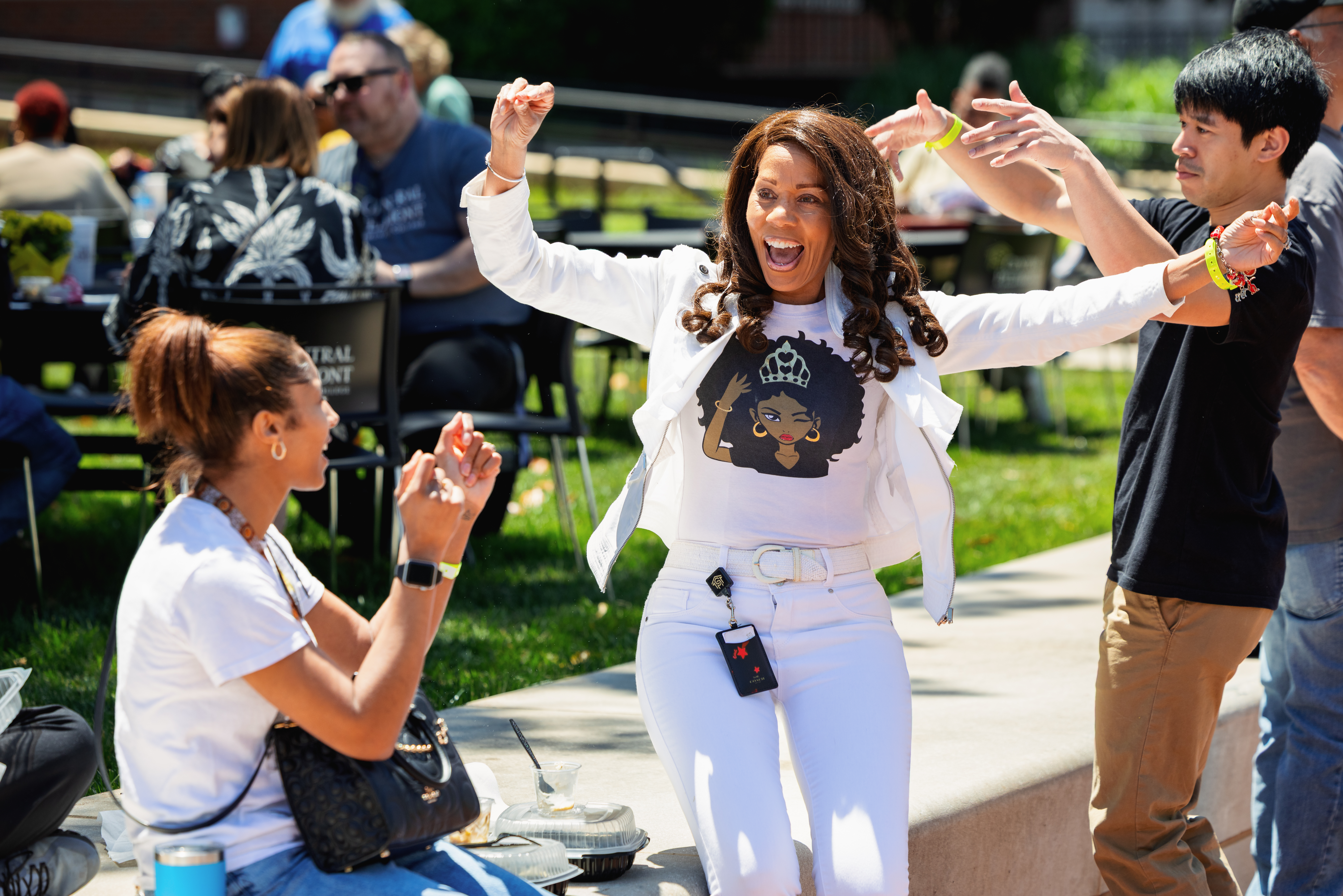 Several staff members dancing on Central campus quad