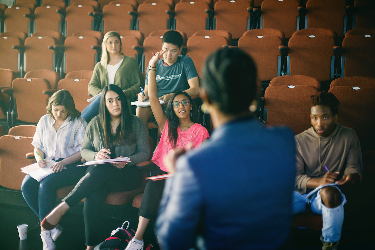 A small group of students sitting in an auditorium