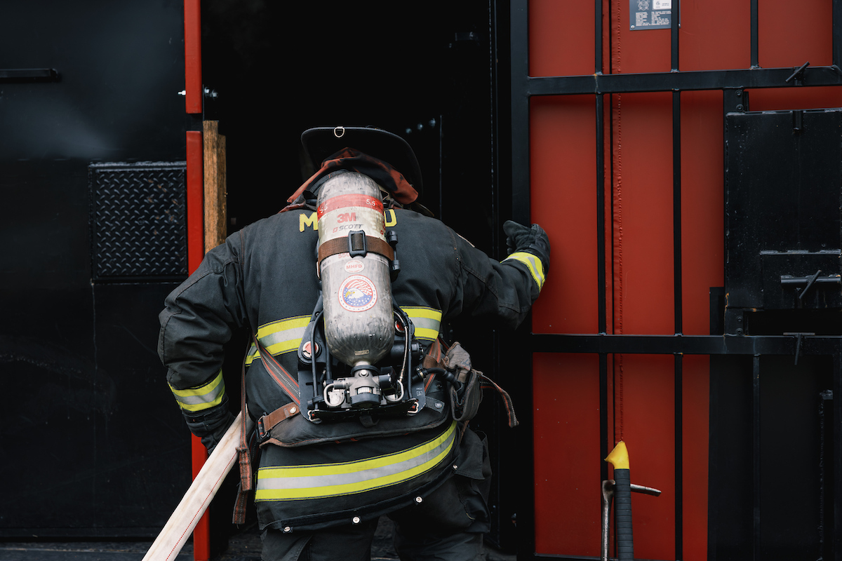 Fire safety student preparing to enter a mock fire scenario