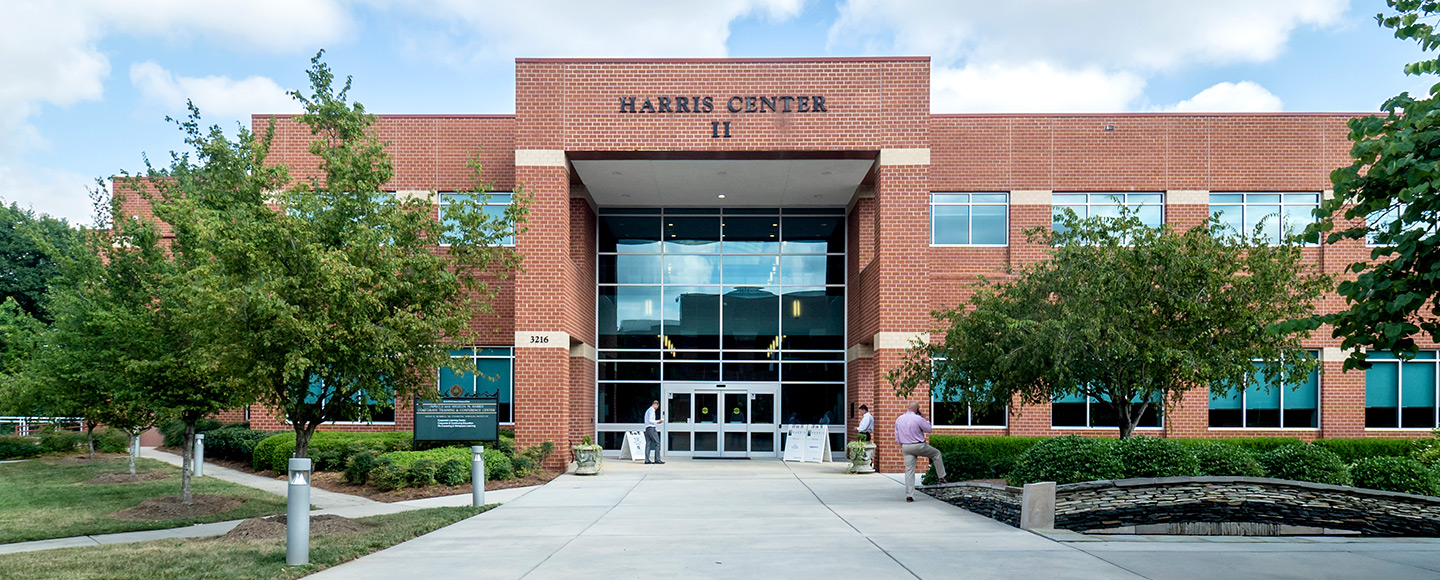 Harris Conference Center entrance with a paved walkway and landscaped beds