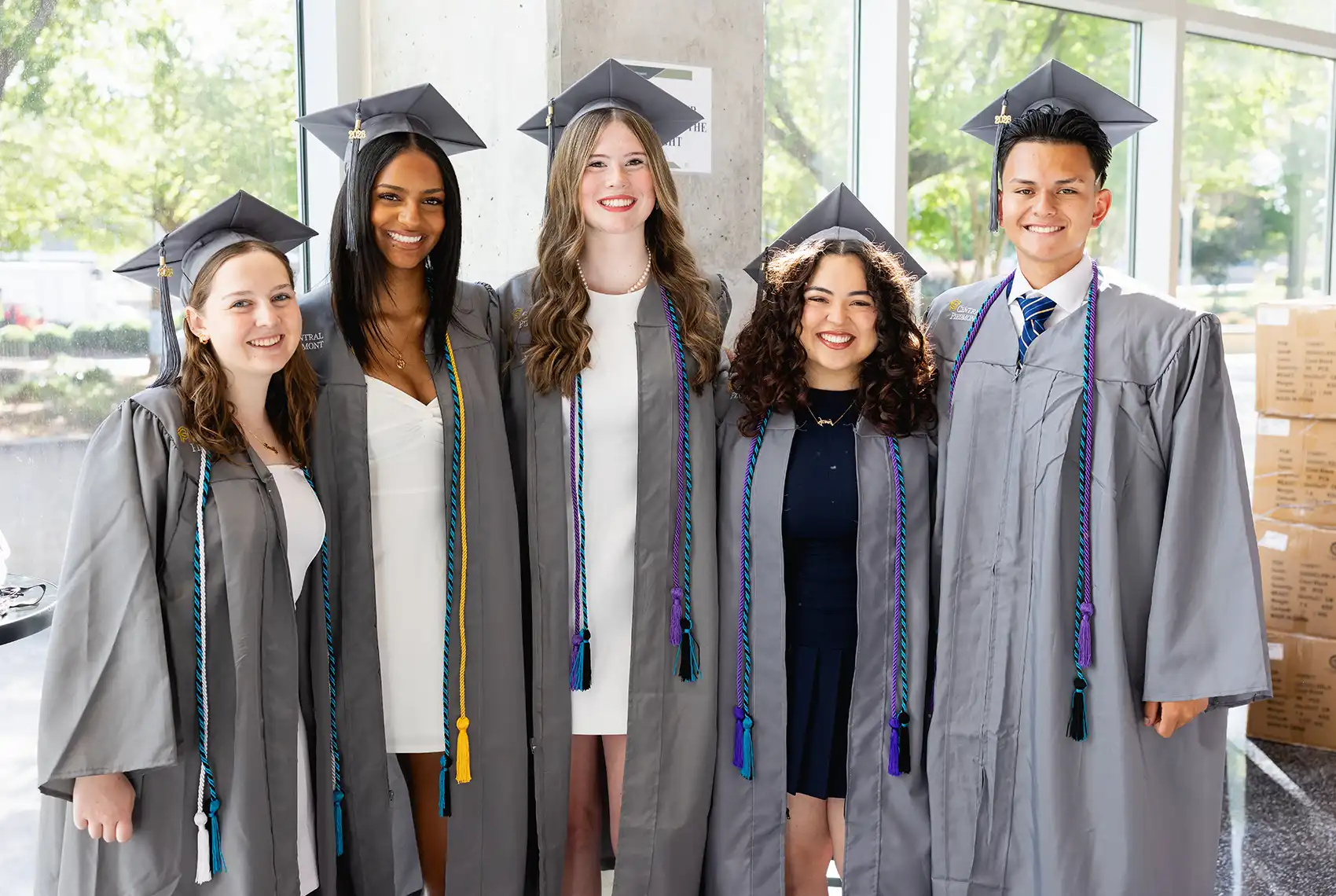Five Central Piedmont students in caps and gowns at commencement