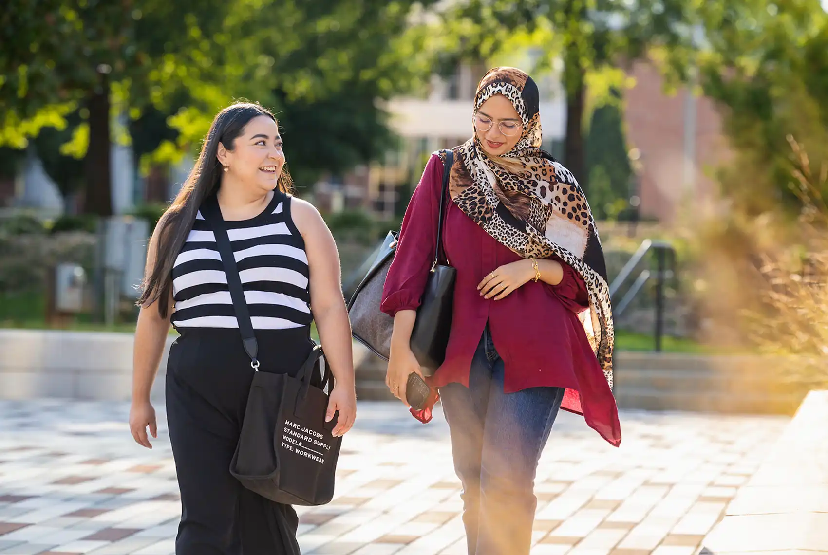 Two students walking in the sunshine on Central Piedmont's campus