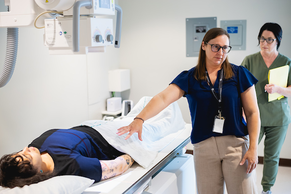 Radiography faculty member providing instruction in a simulation environment