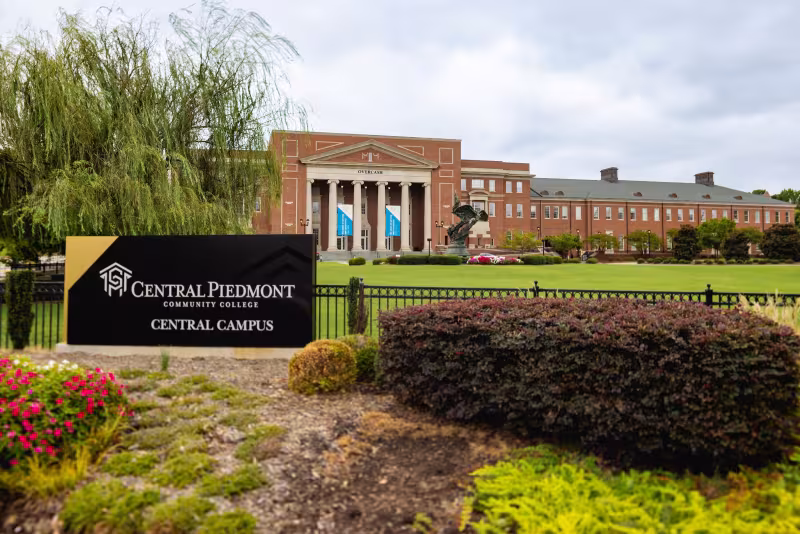 Central Piedmont monument sign at the Central Campus entrance beside a willow tree