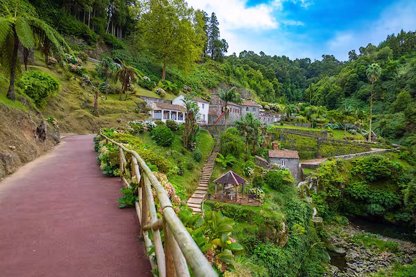 Path leading to hillside houses in a green area of Portugal.