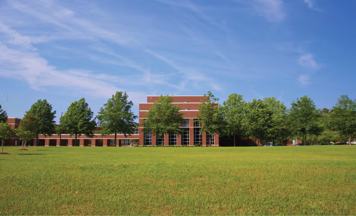 Elizabeth City State University campus building beyond a wide green lawn