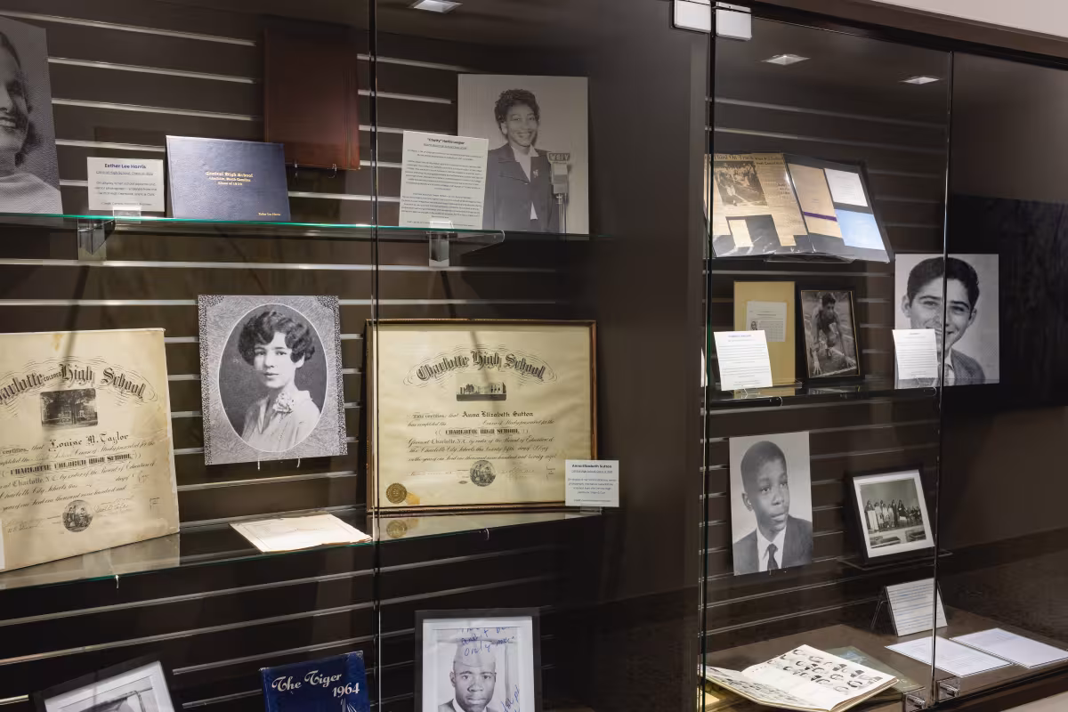 Artifacts from the history of the college on display behind glass