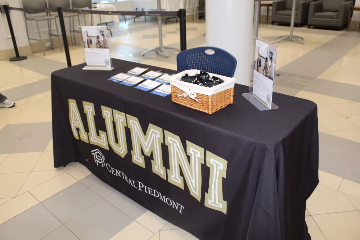 Table set up in Parr Center with cloth that reads "Alumni" 